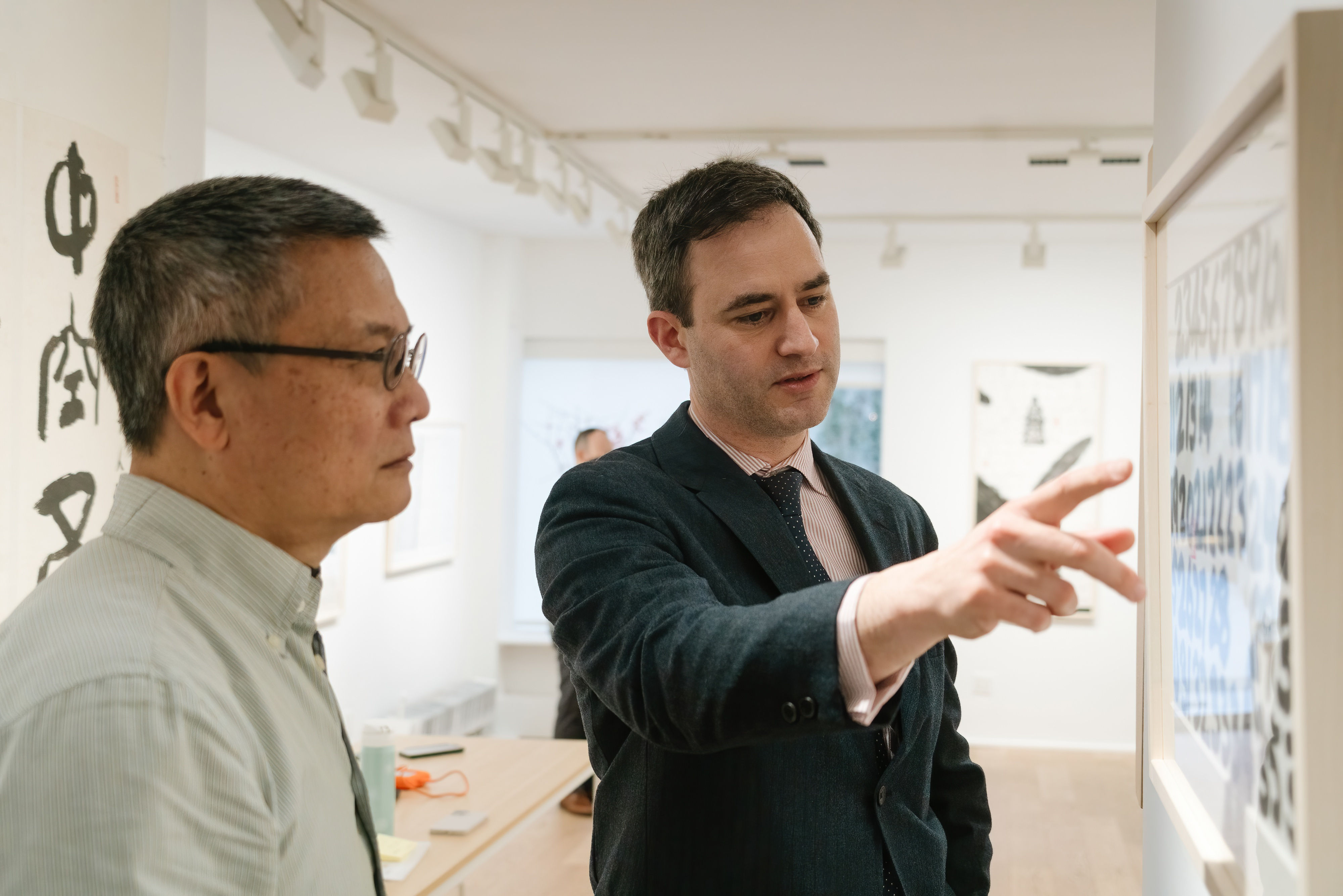 A person pointing at another person