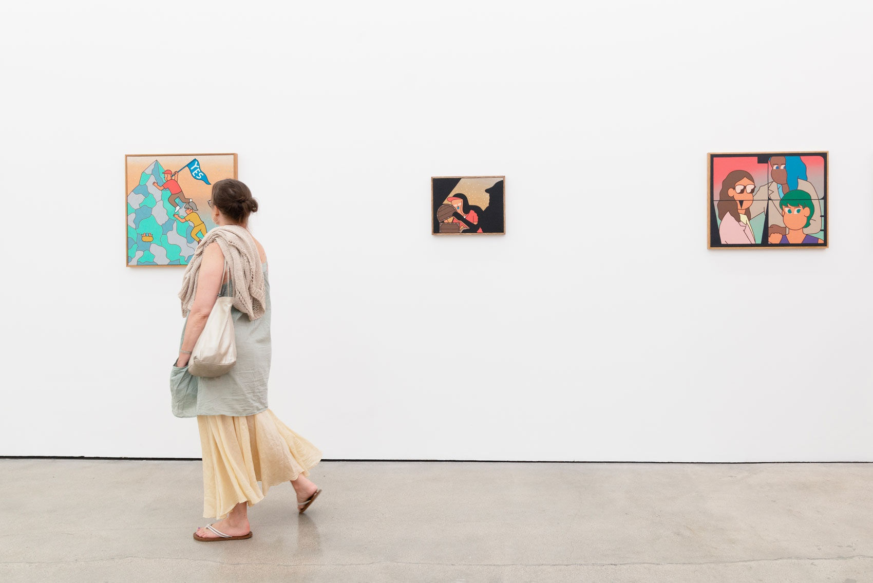 Someone viewing Jun Oson's work at the opening reception