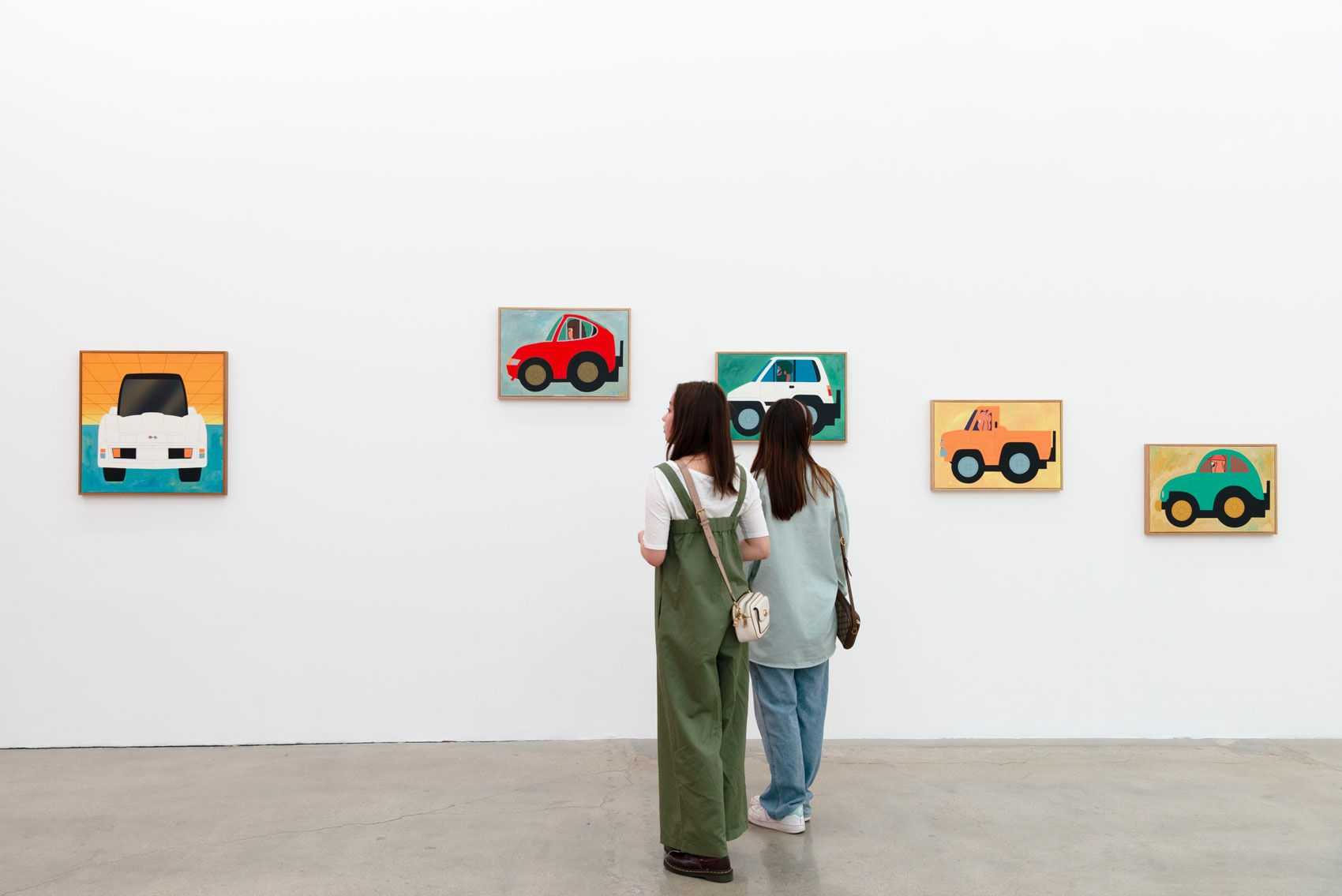 Two people viewing Jun Oson's work at the Los Angeles gallery