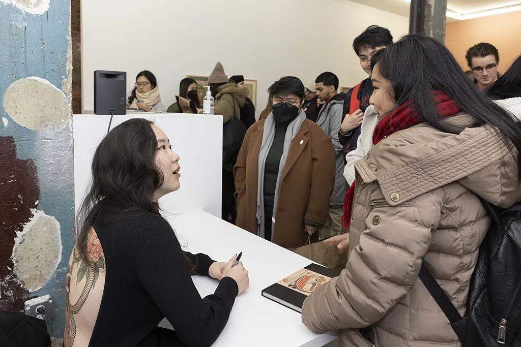 Felicia Chiao signing books with fans