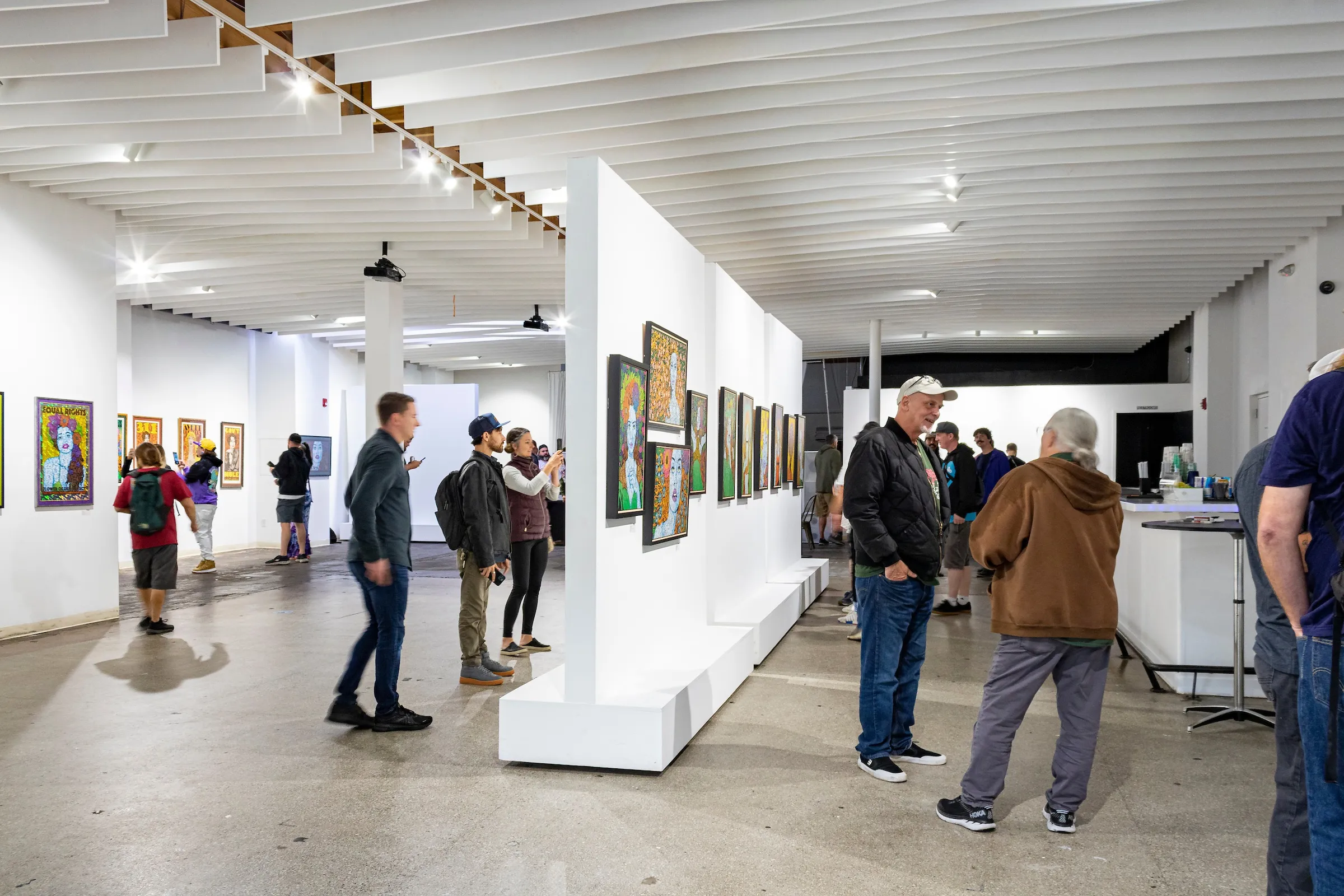 Photograph of a crowd admiring Chuck Sperry's artwork.