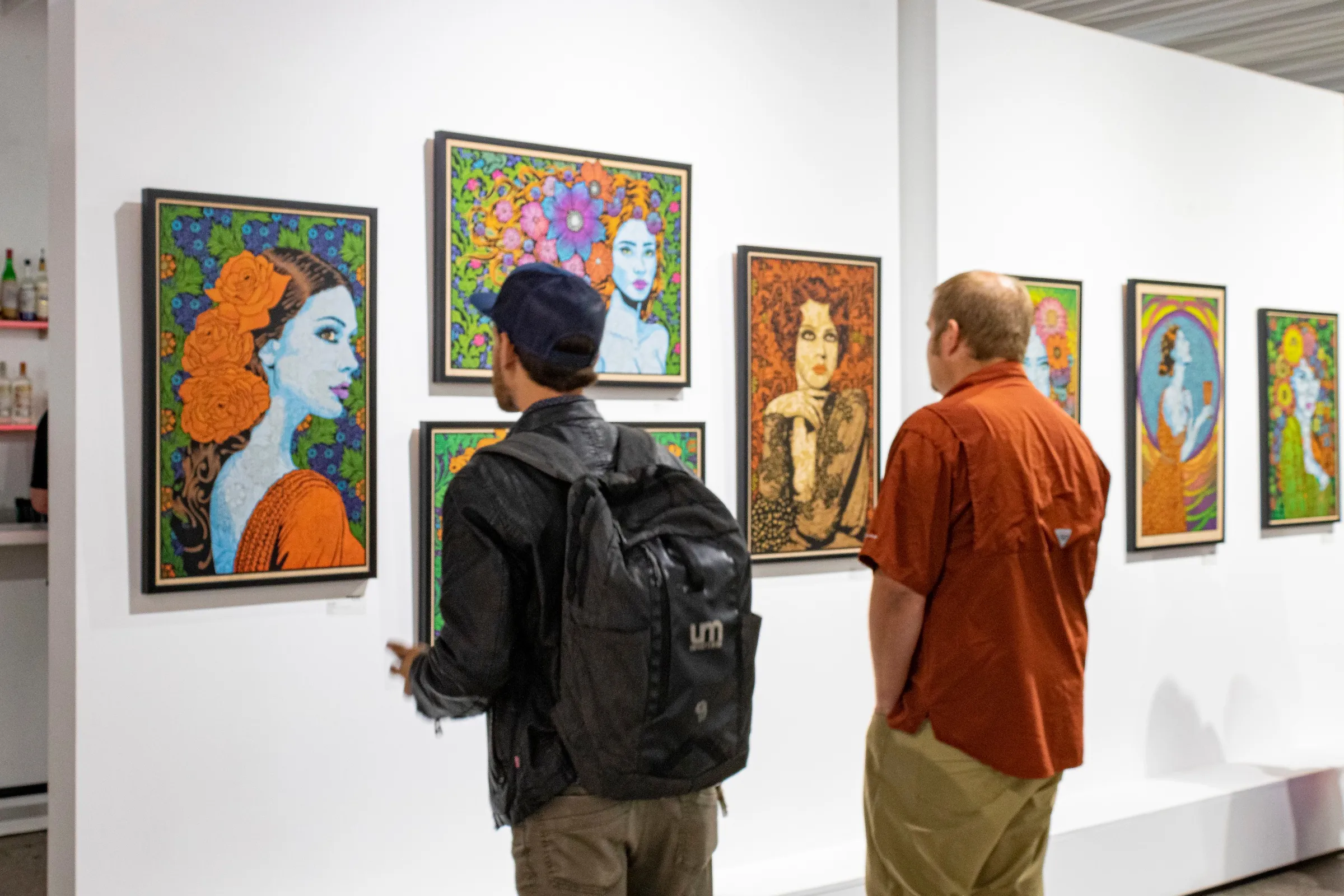 Photograph of a crowd admiring Chuck Sperry's artwork.