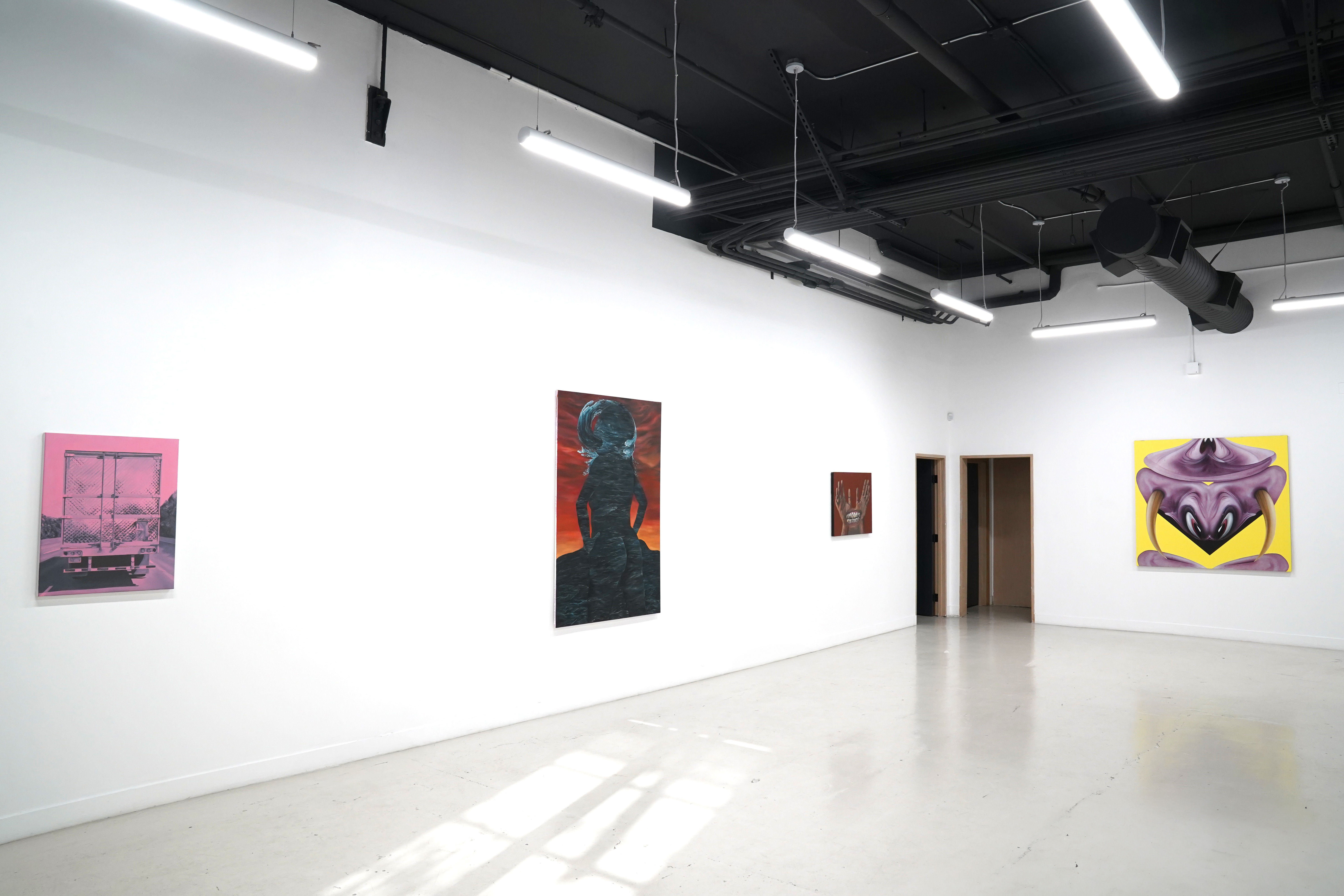 photo of the gallery with paintings hangiing on the wall