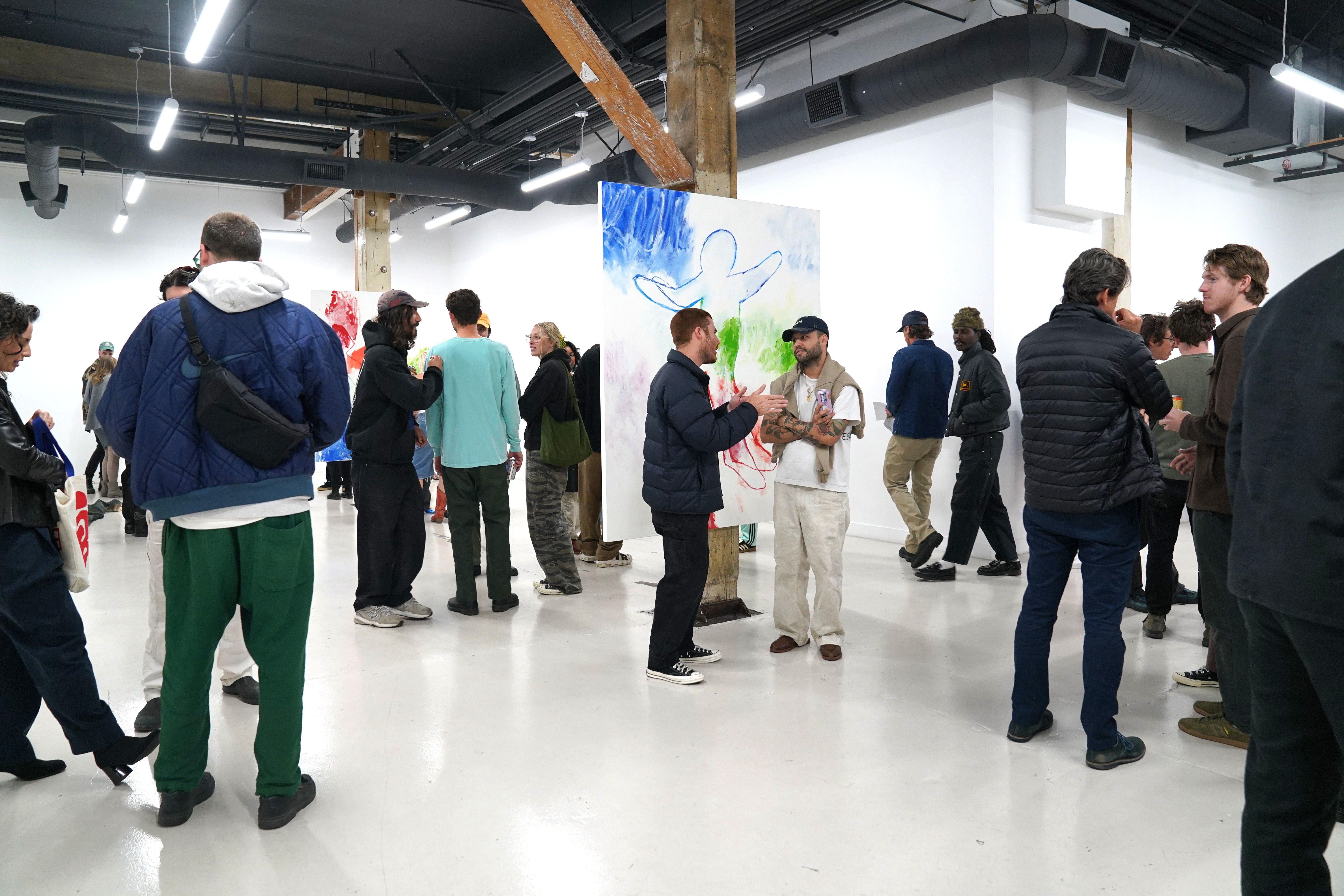 photo of a crowd of people in the art gallery