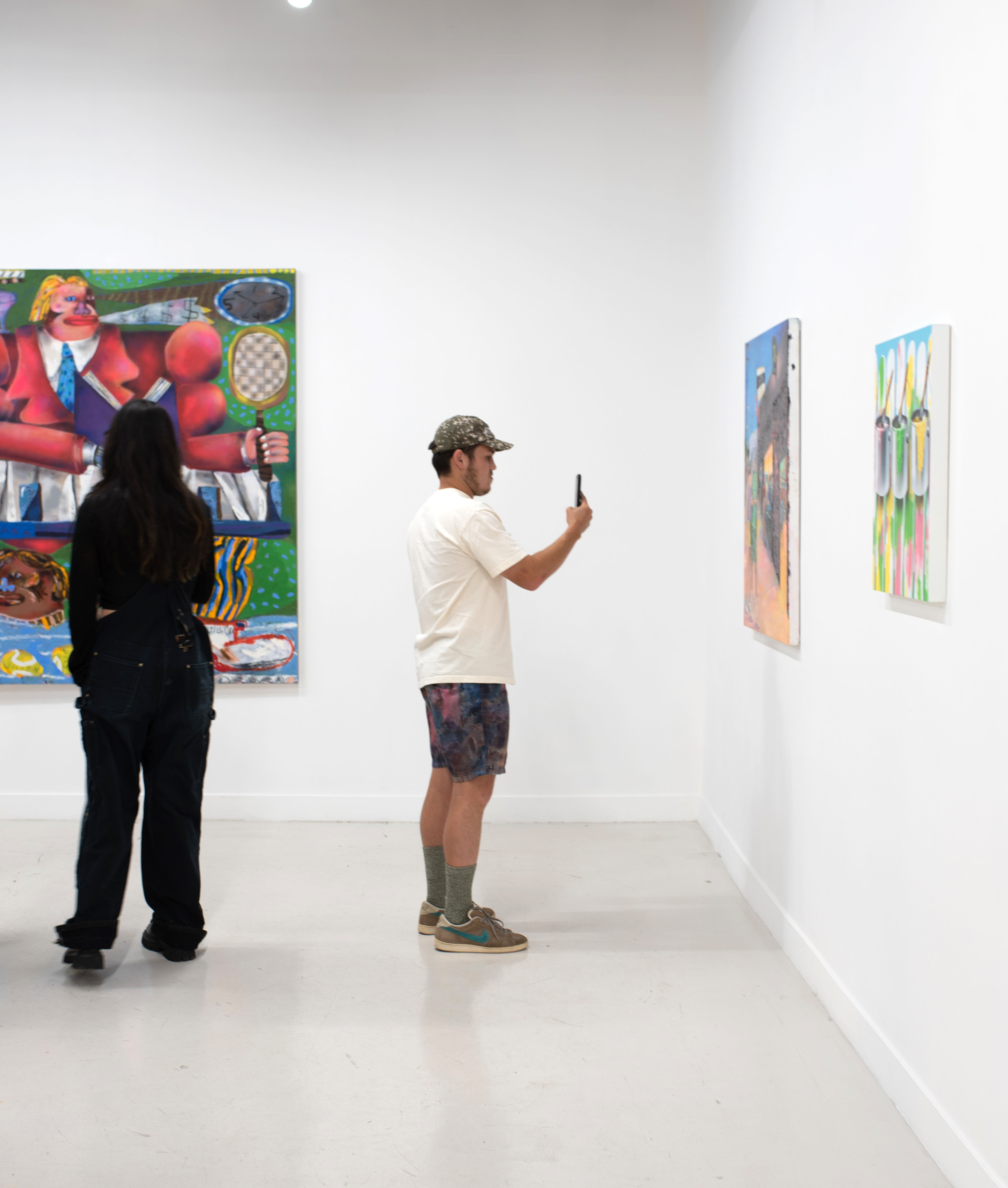 photo of a crowd of people in an art gallery
