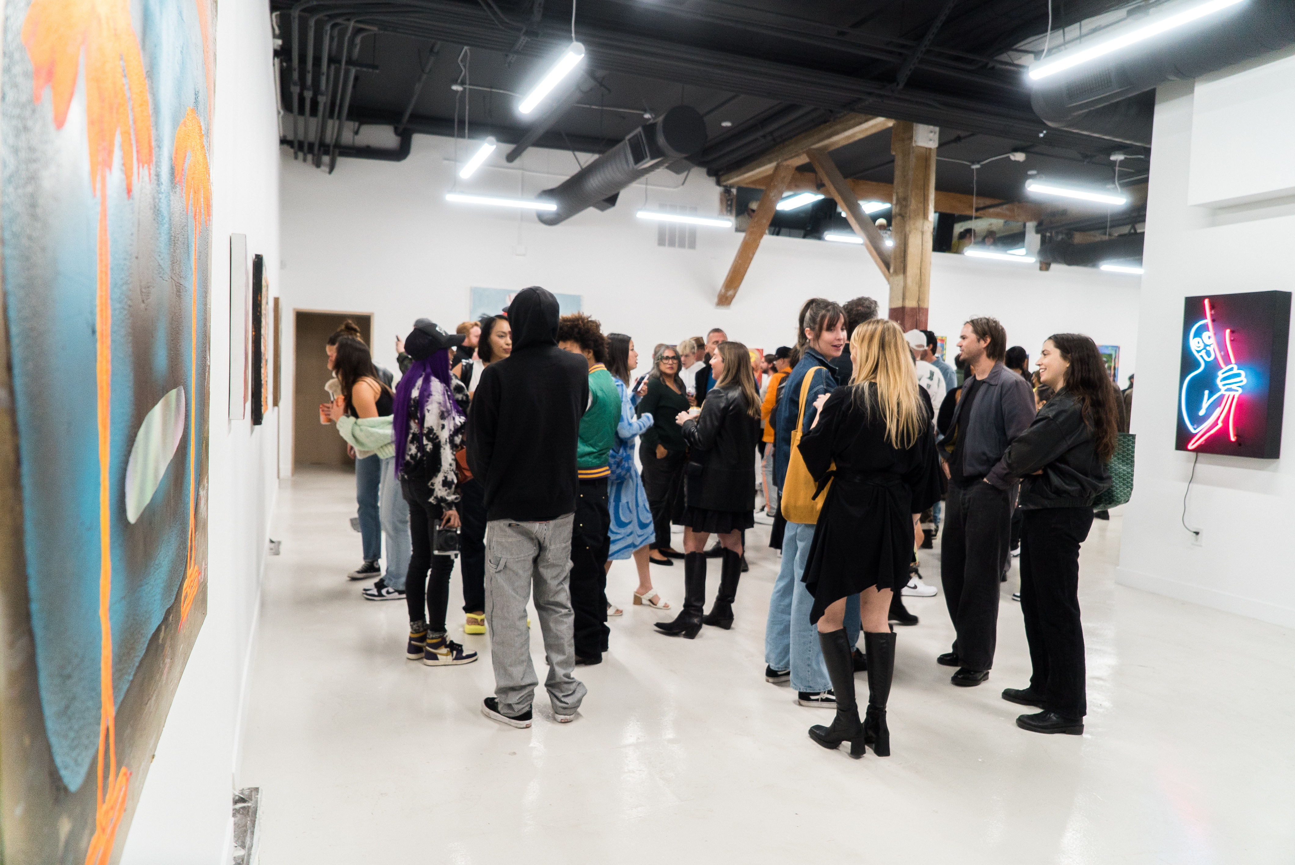 photo of a crowd of people in the art gallery