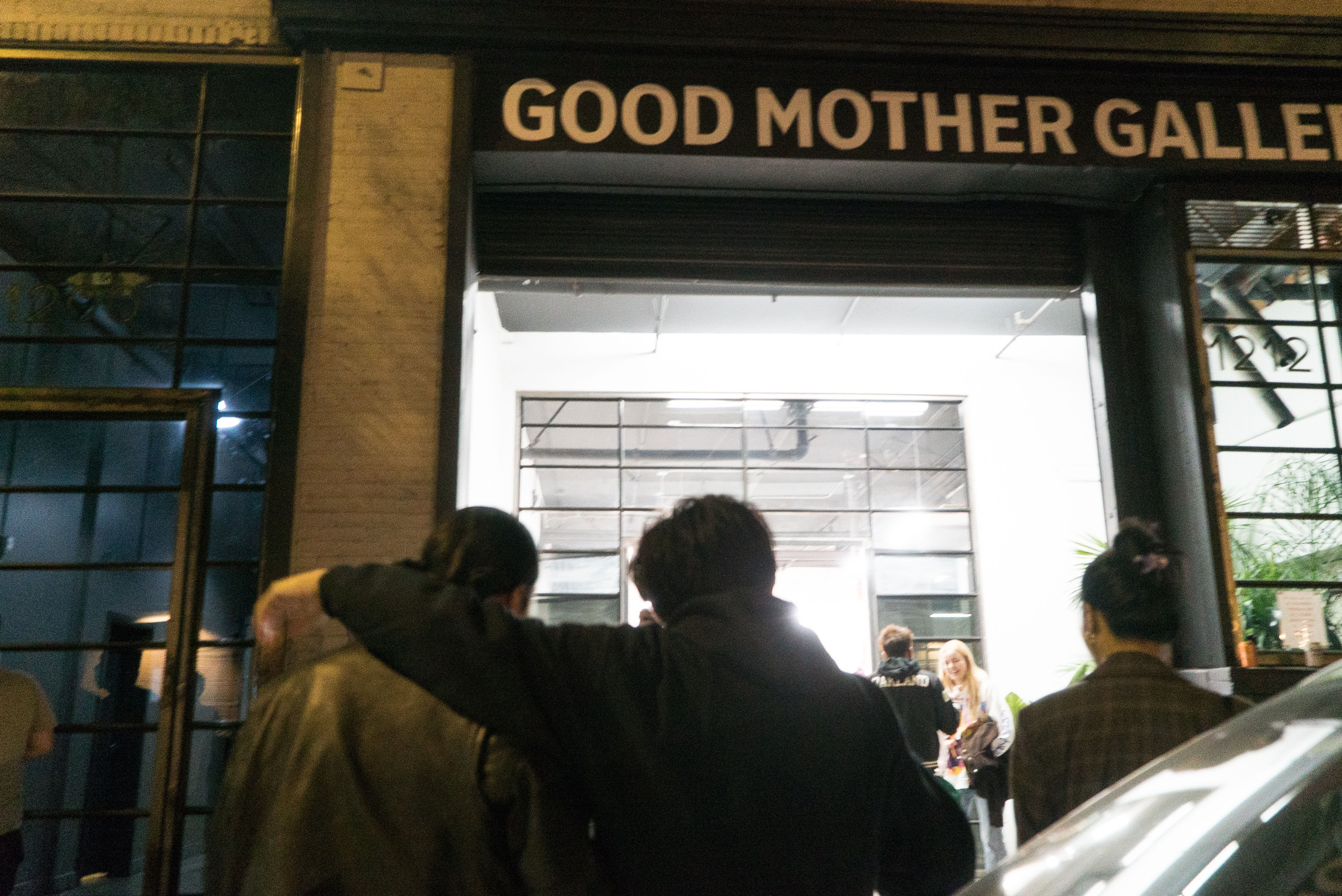 photo of a crowd of people in front of the art gallery outside