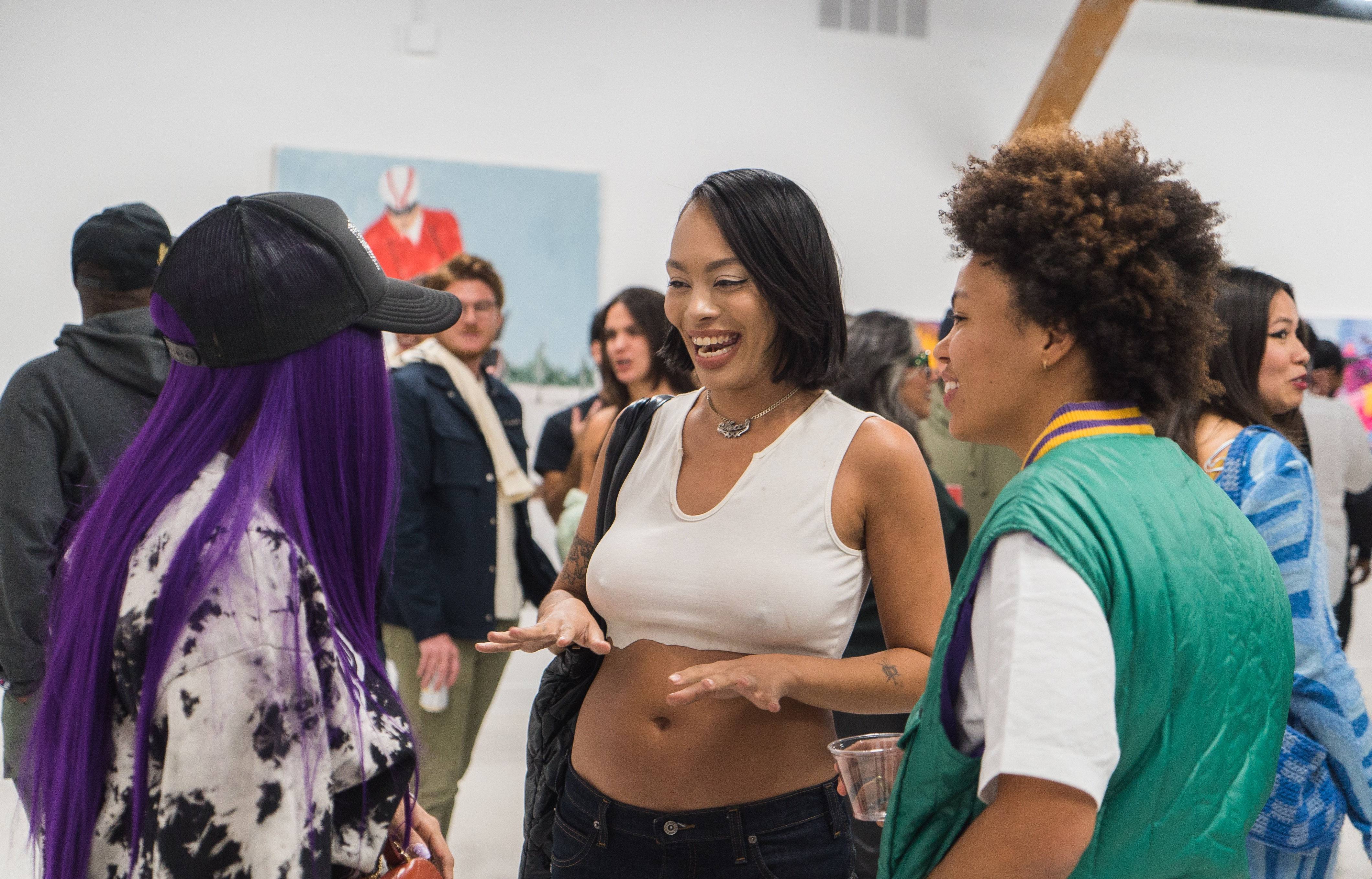 photo of a crowd of people in the art gallery