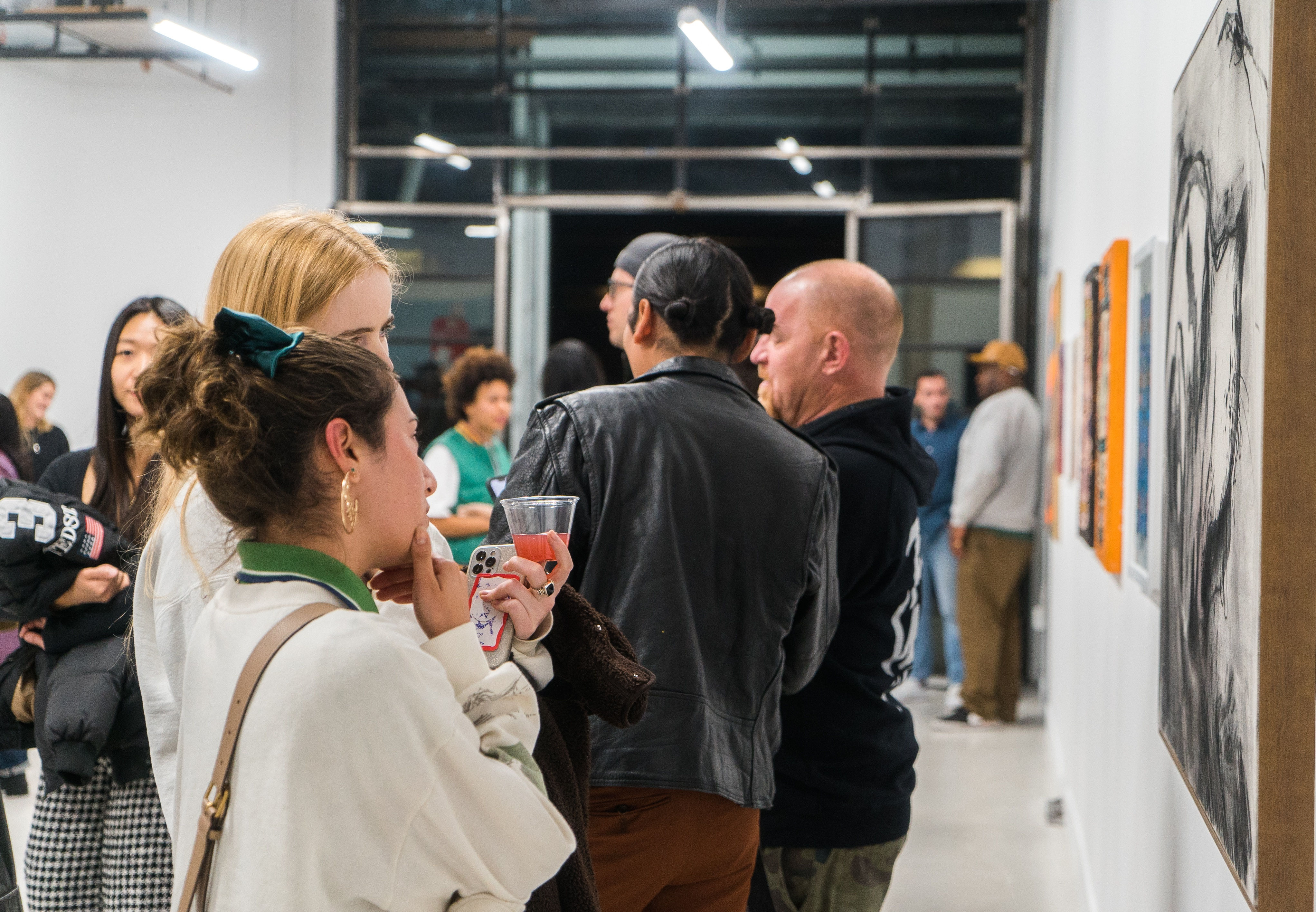 photo of a crowd of people in the art gallery