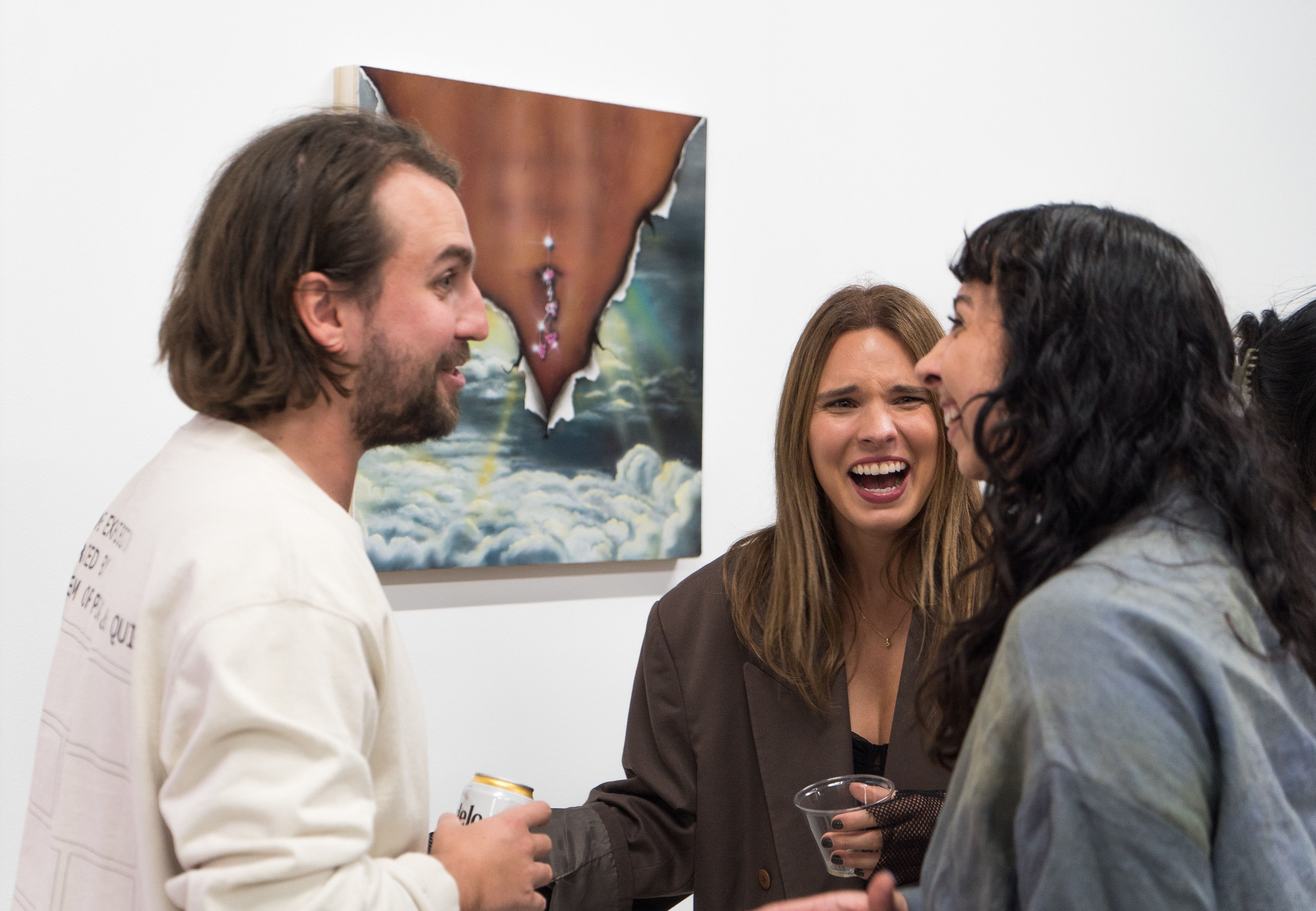 photo of a crowd of people in the art gallery
