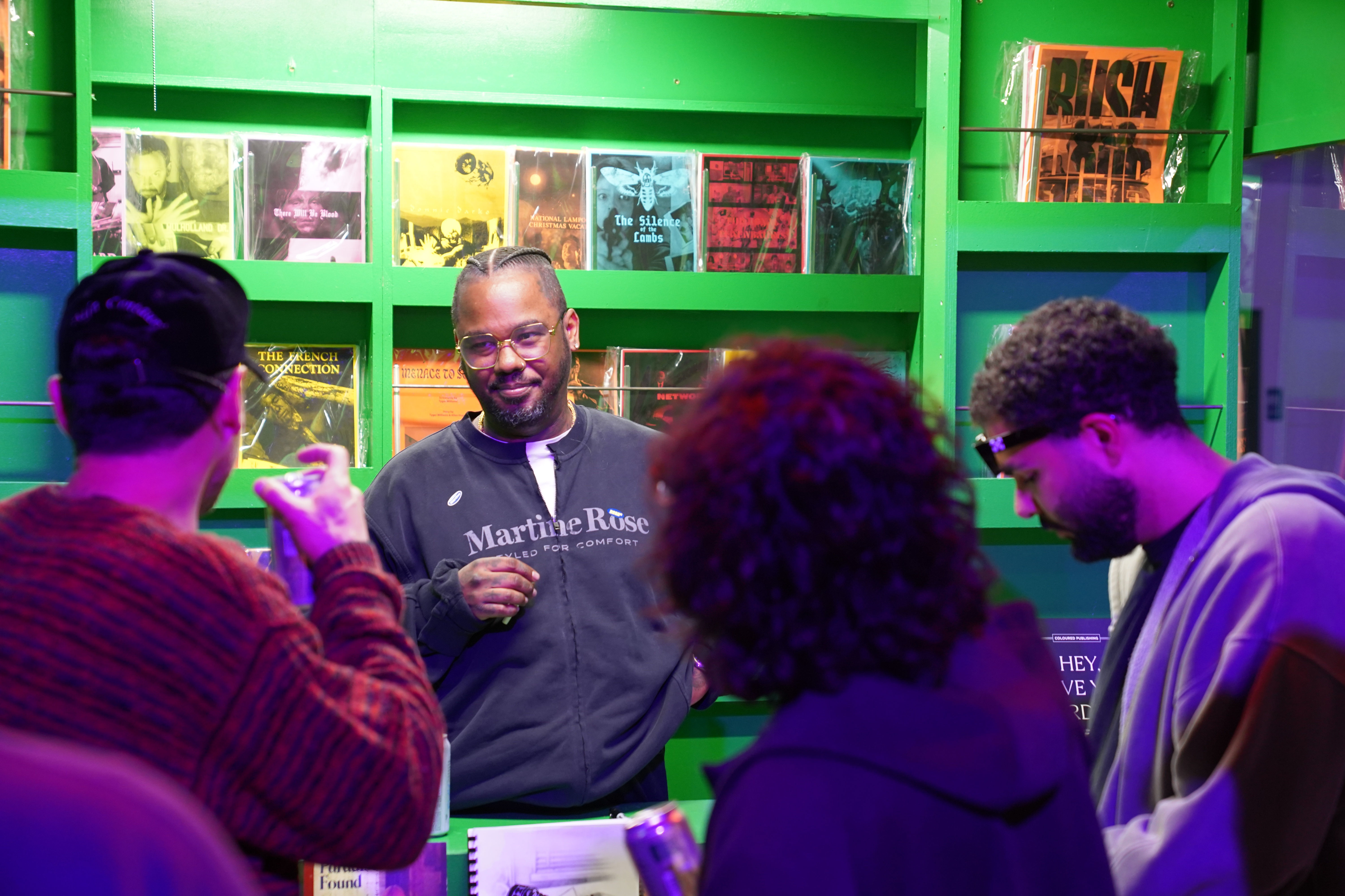 photo of the artist, Devin Troy Strother, standing in his installation