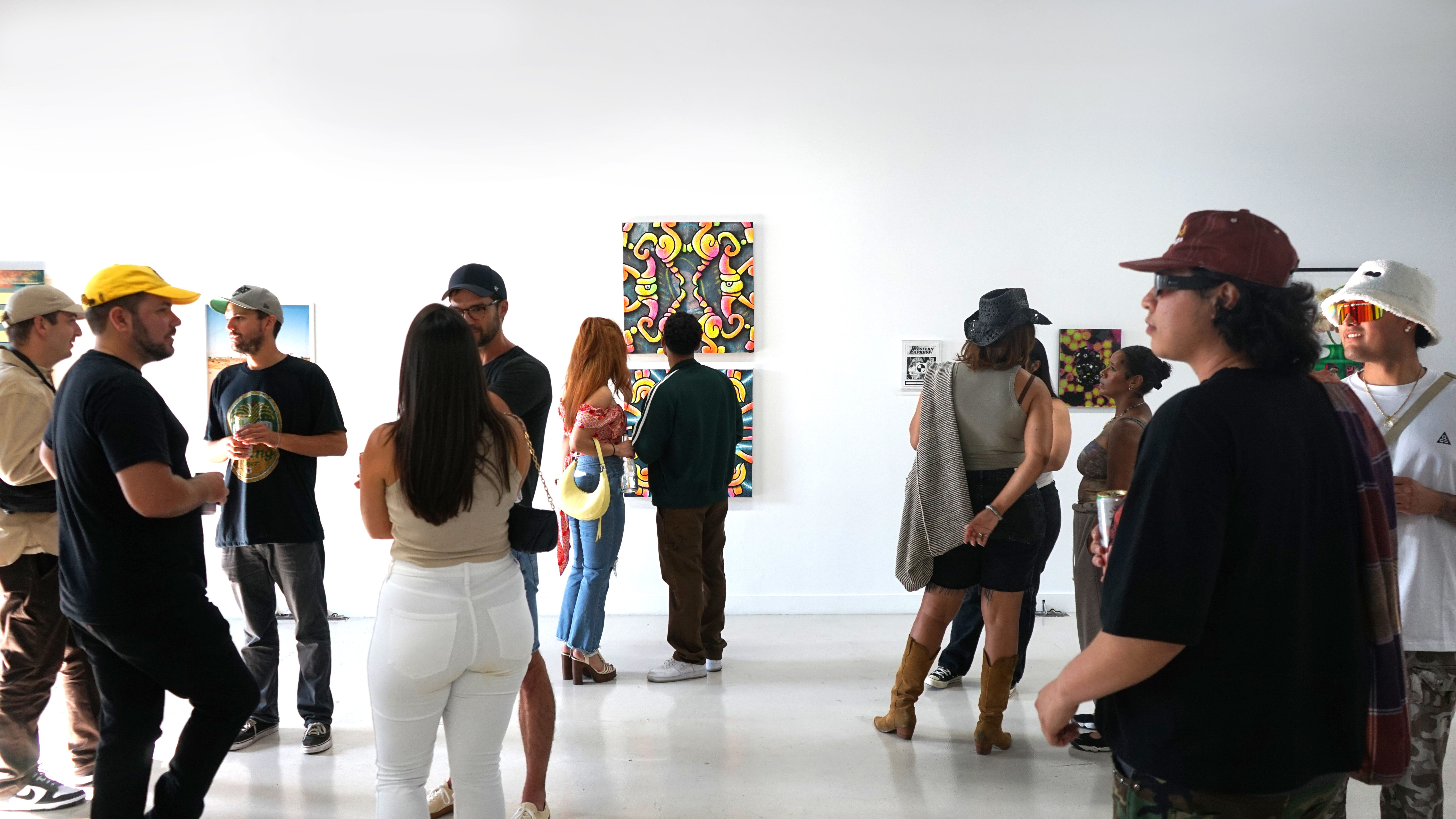 photo of a crowd of people in the art gallery