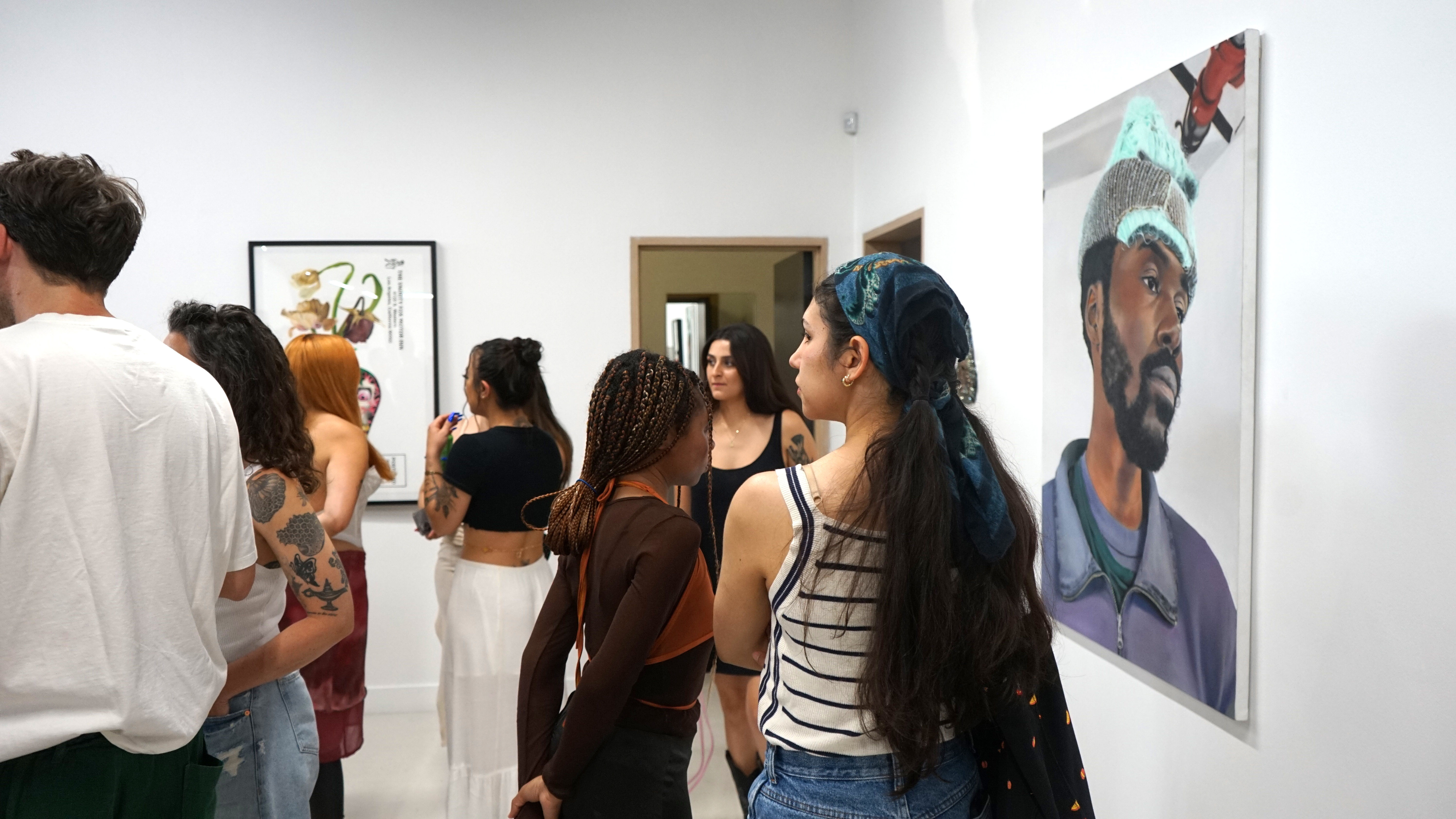 photo of a crowd of people in the art gallery