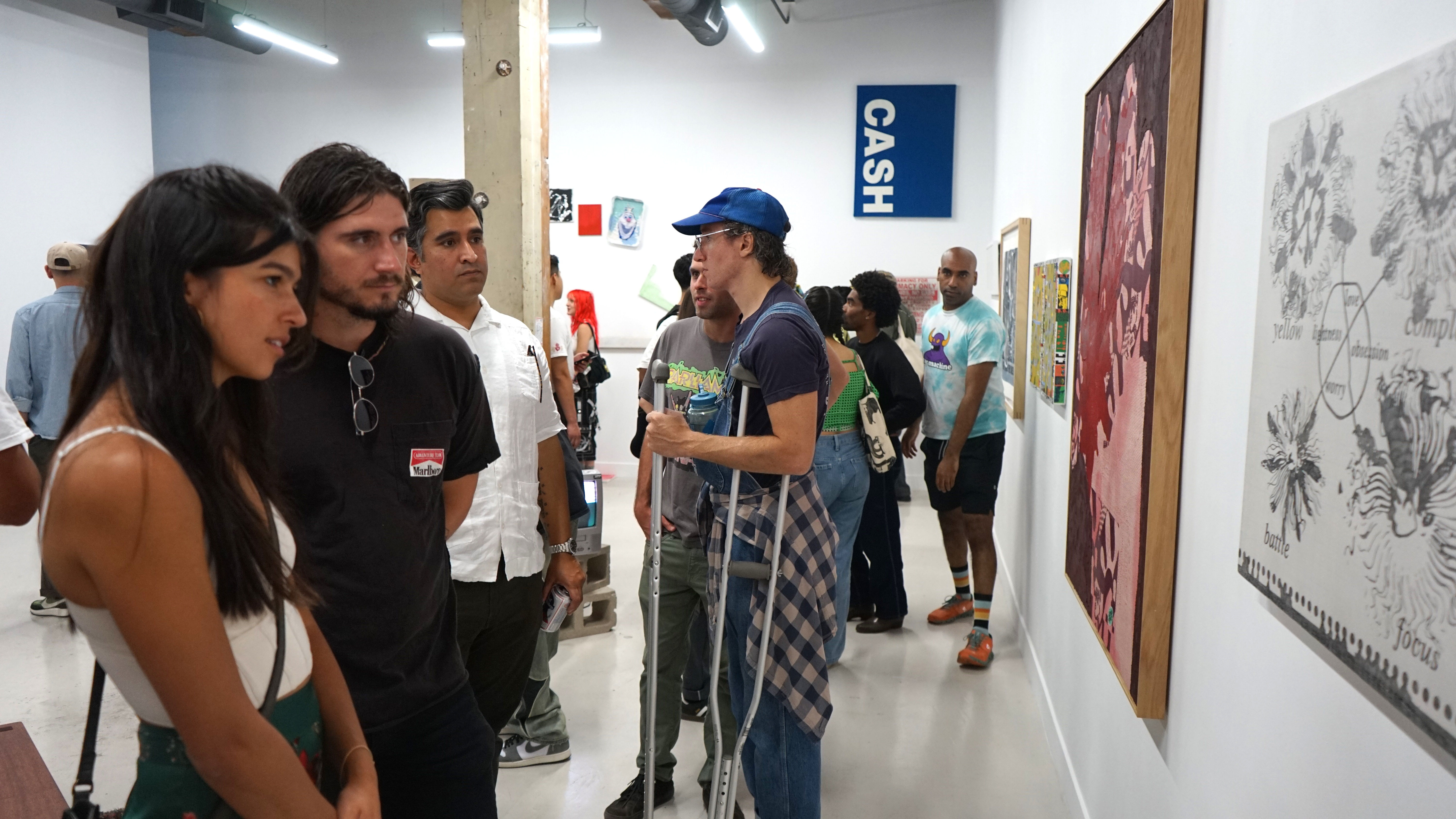 photo of a crowd of people in the art gallery