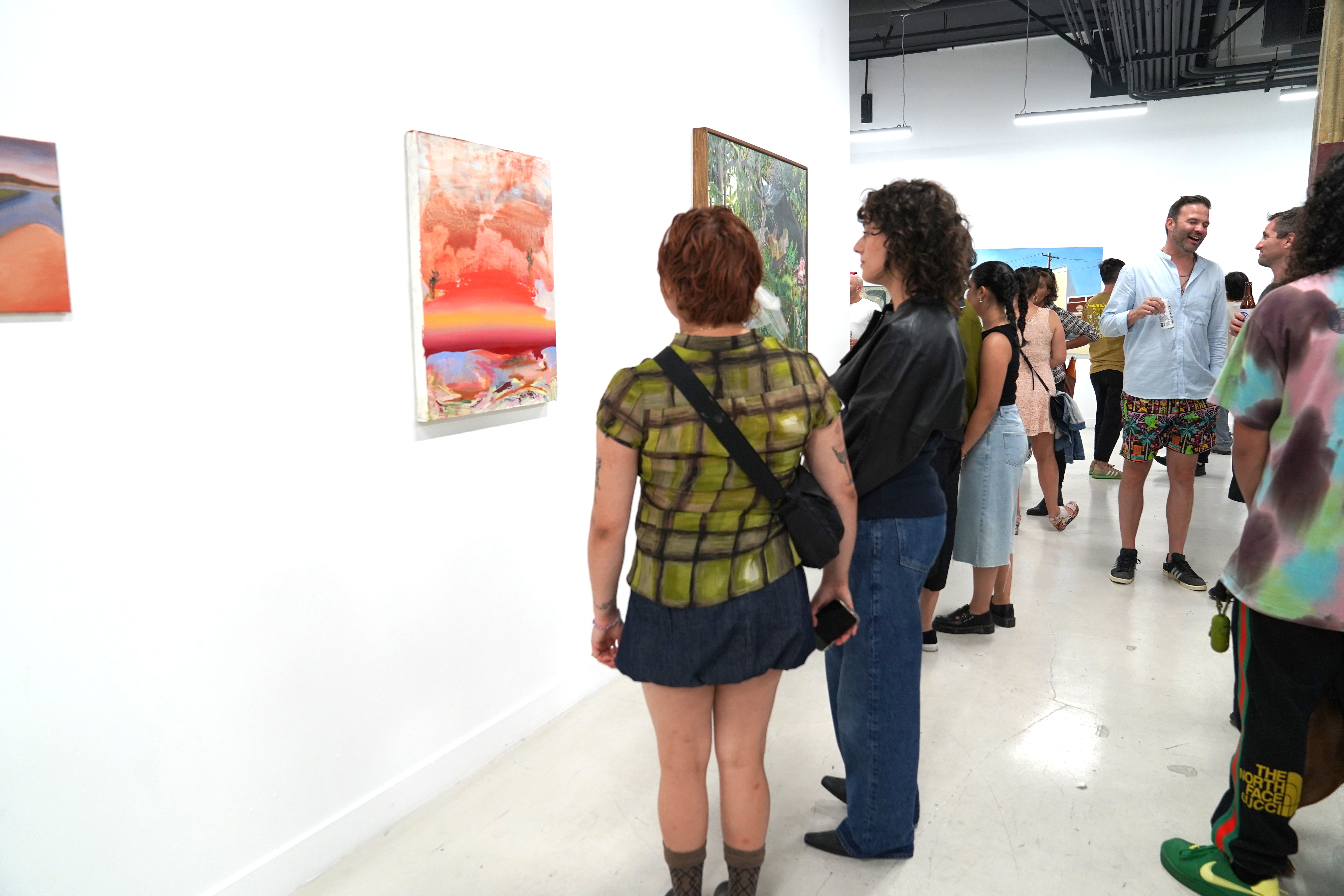 photo of an art gallery full of people