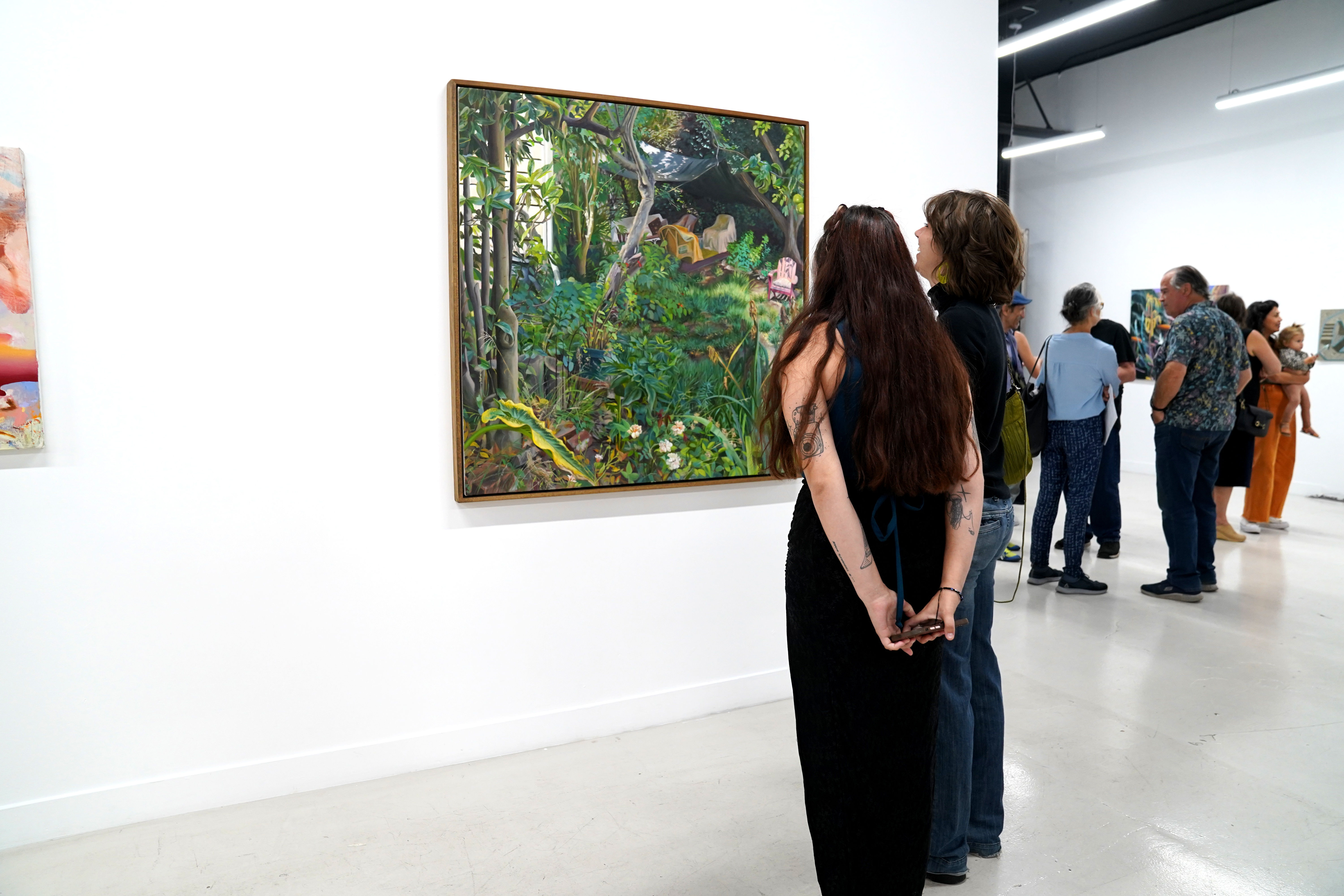 photo of an art gallery full of people