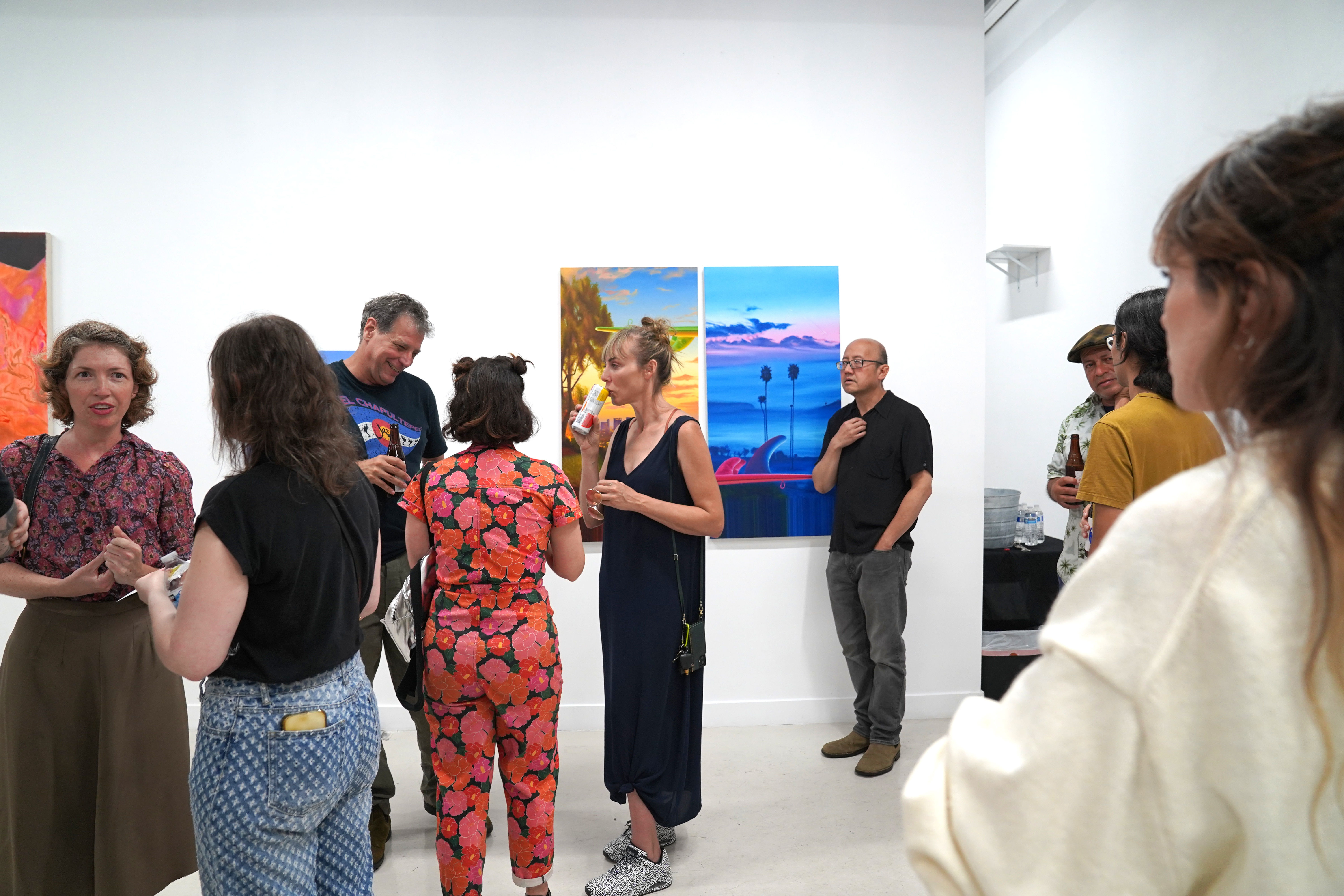 photo of an art gallery full of people