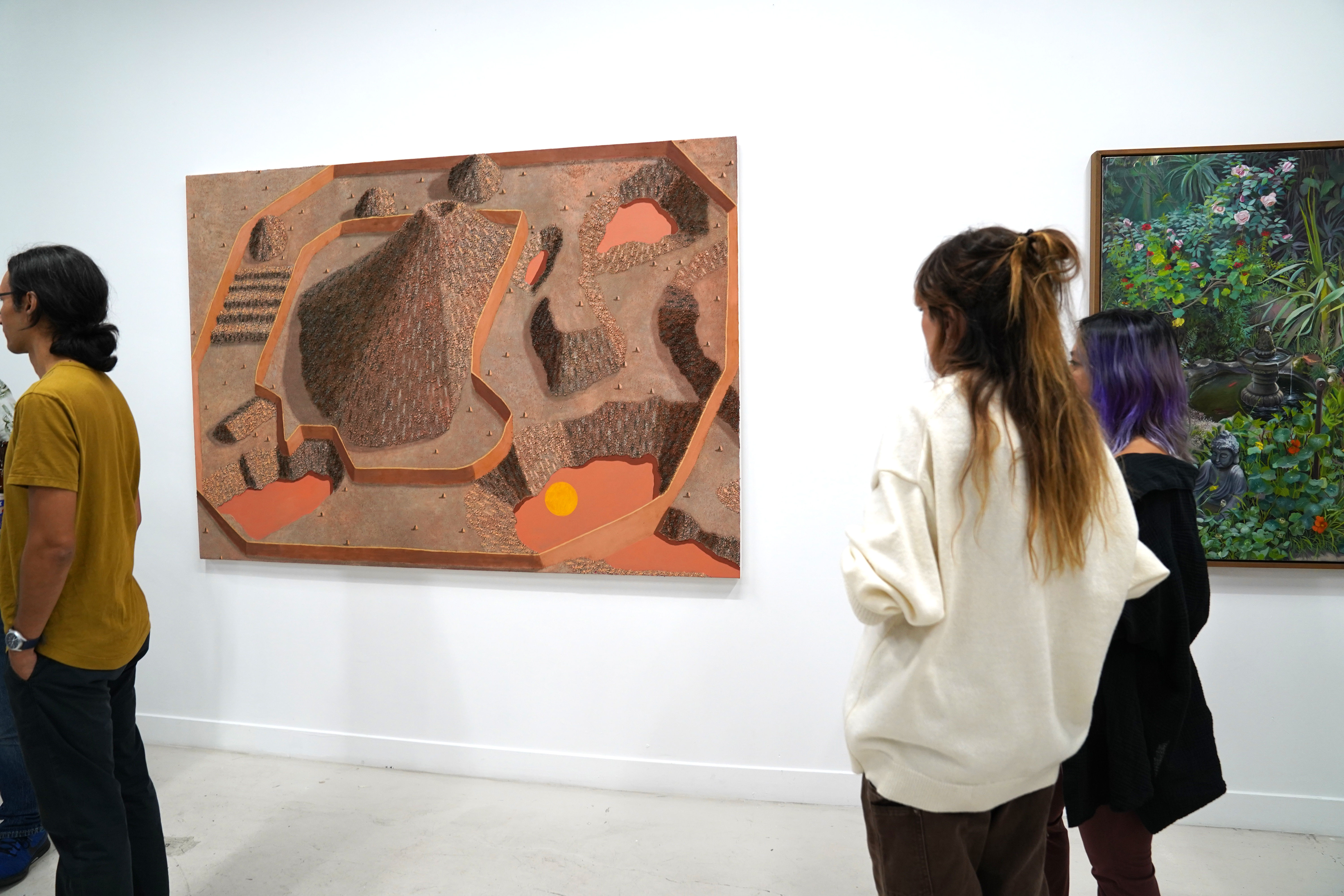 photo of an art gallery full of people