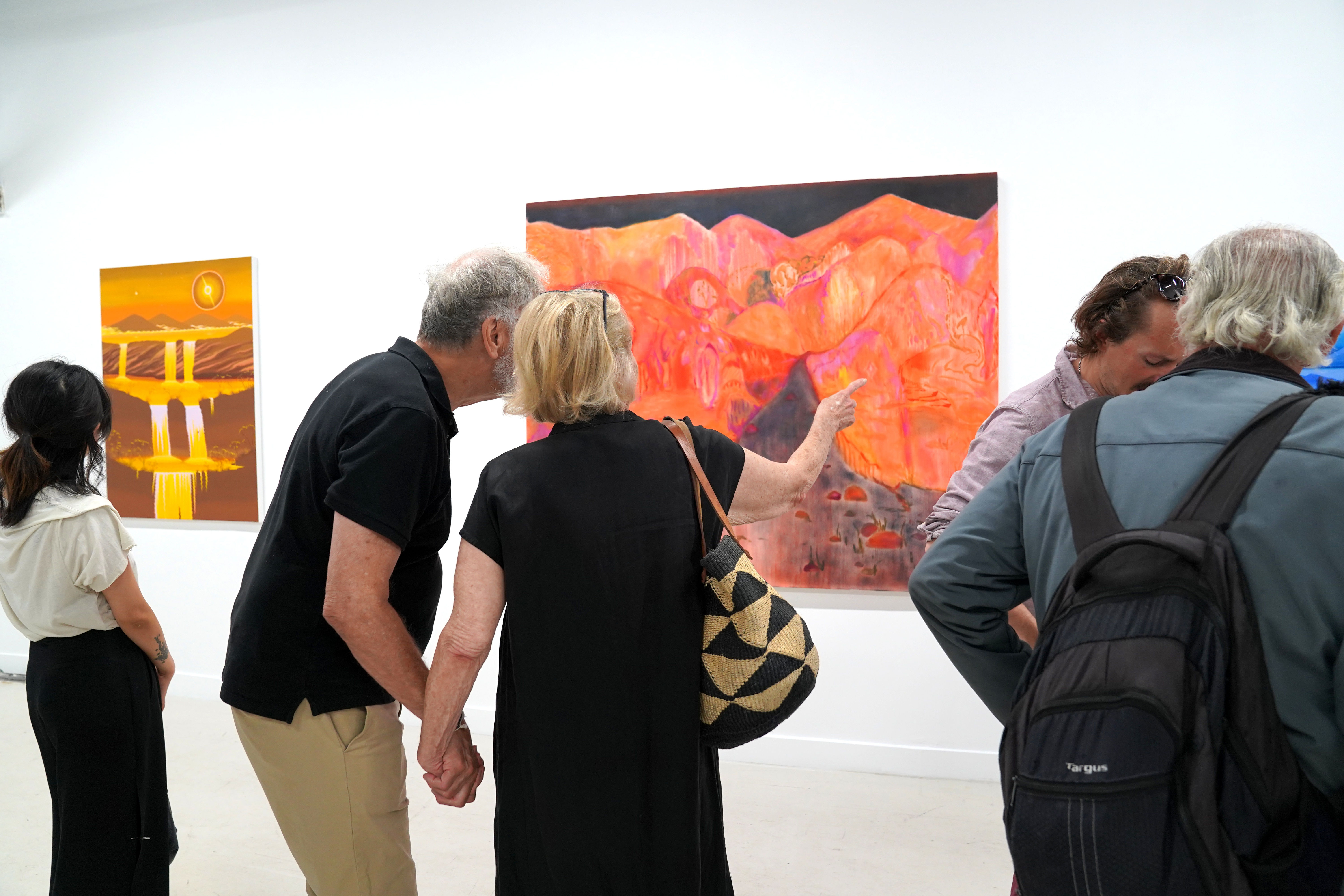 photo of an art gallery full of people