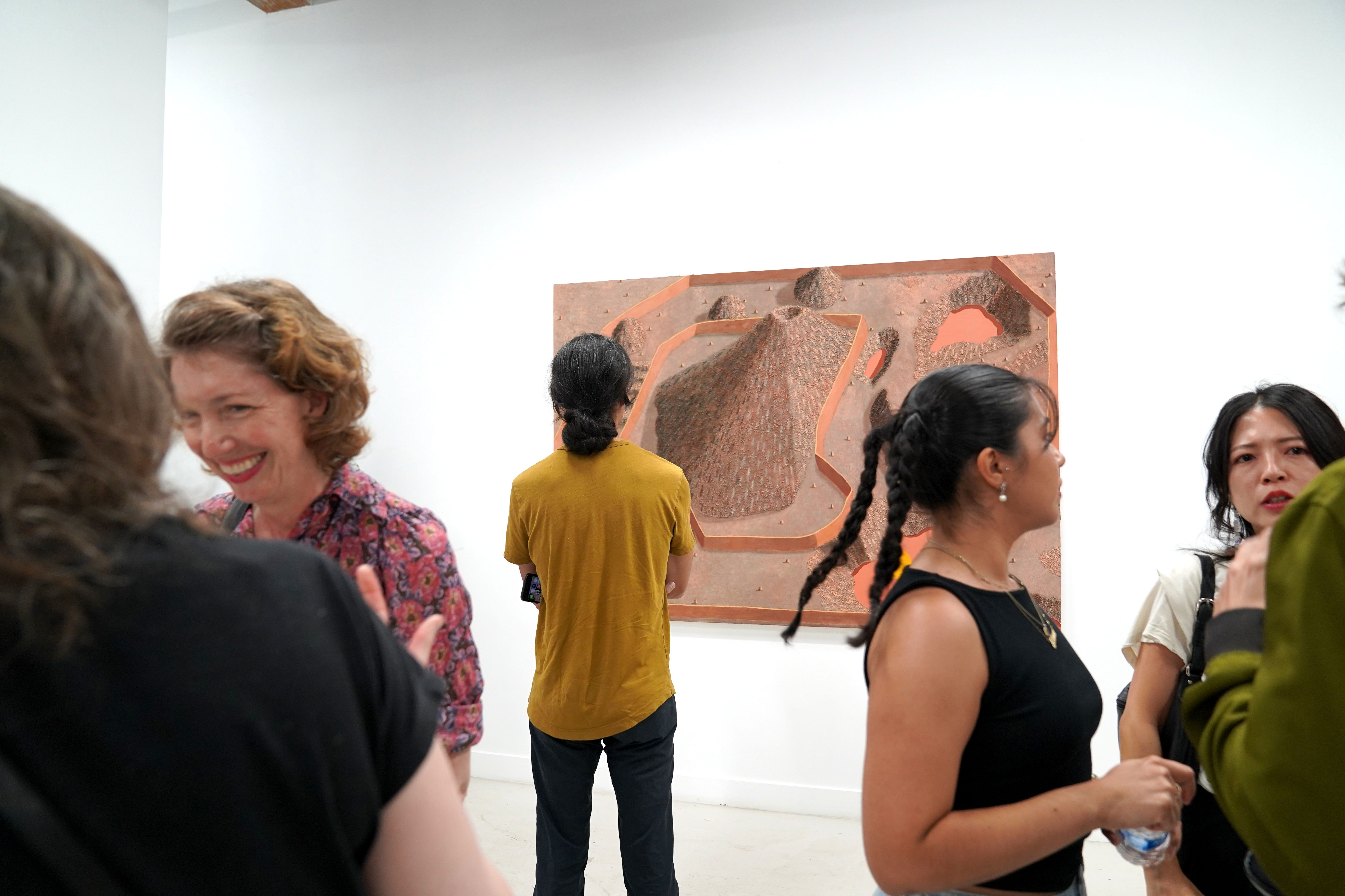 photo of an art gallery full of people