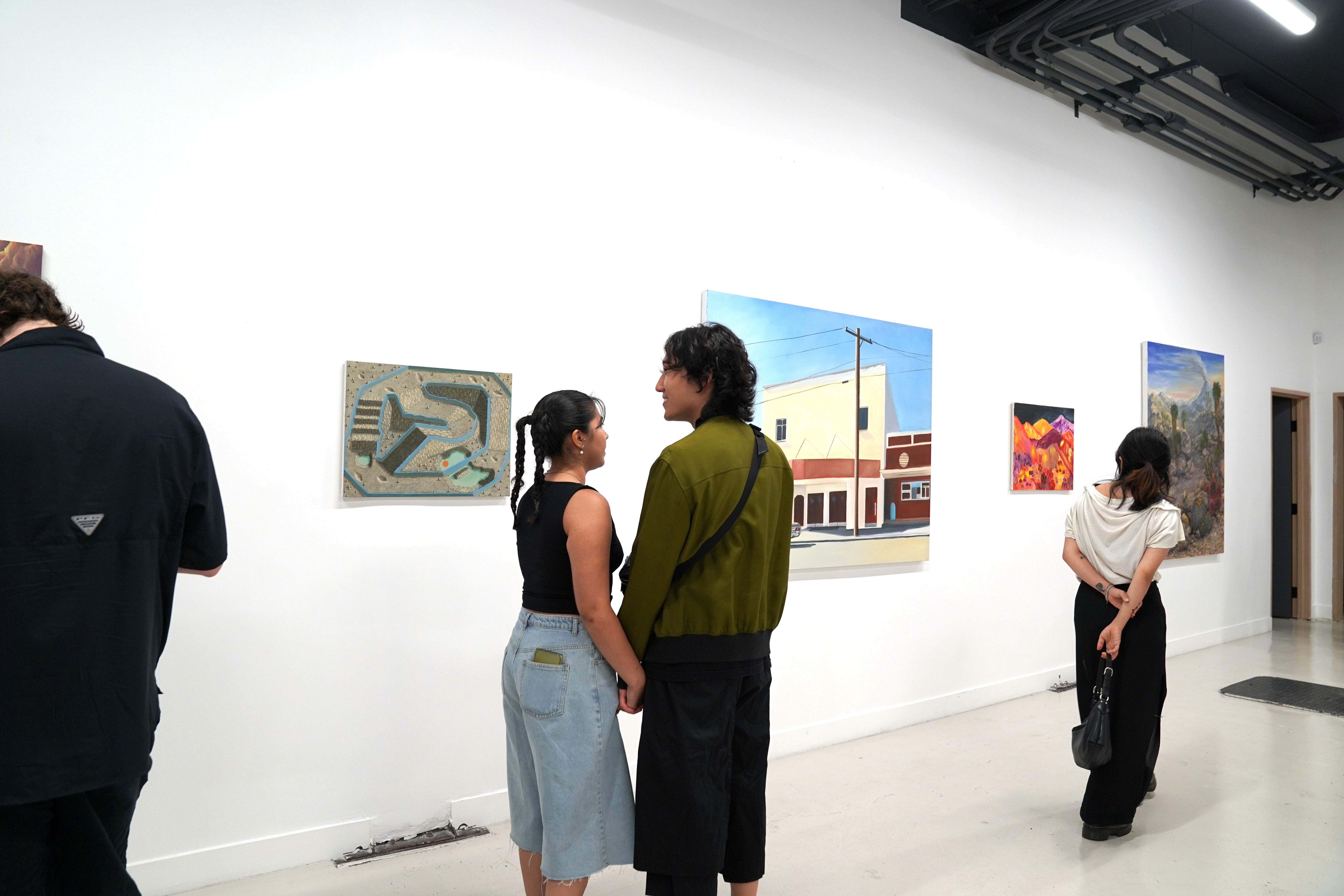 photo of an art gallery full of people