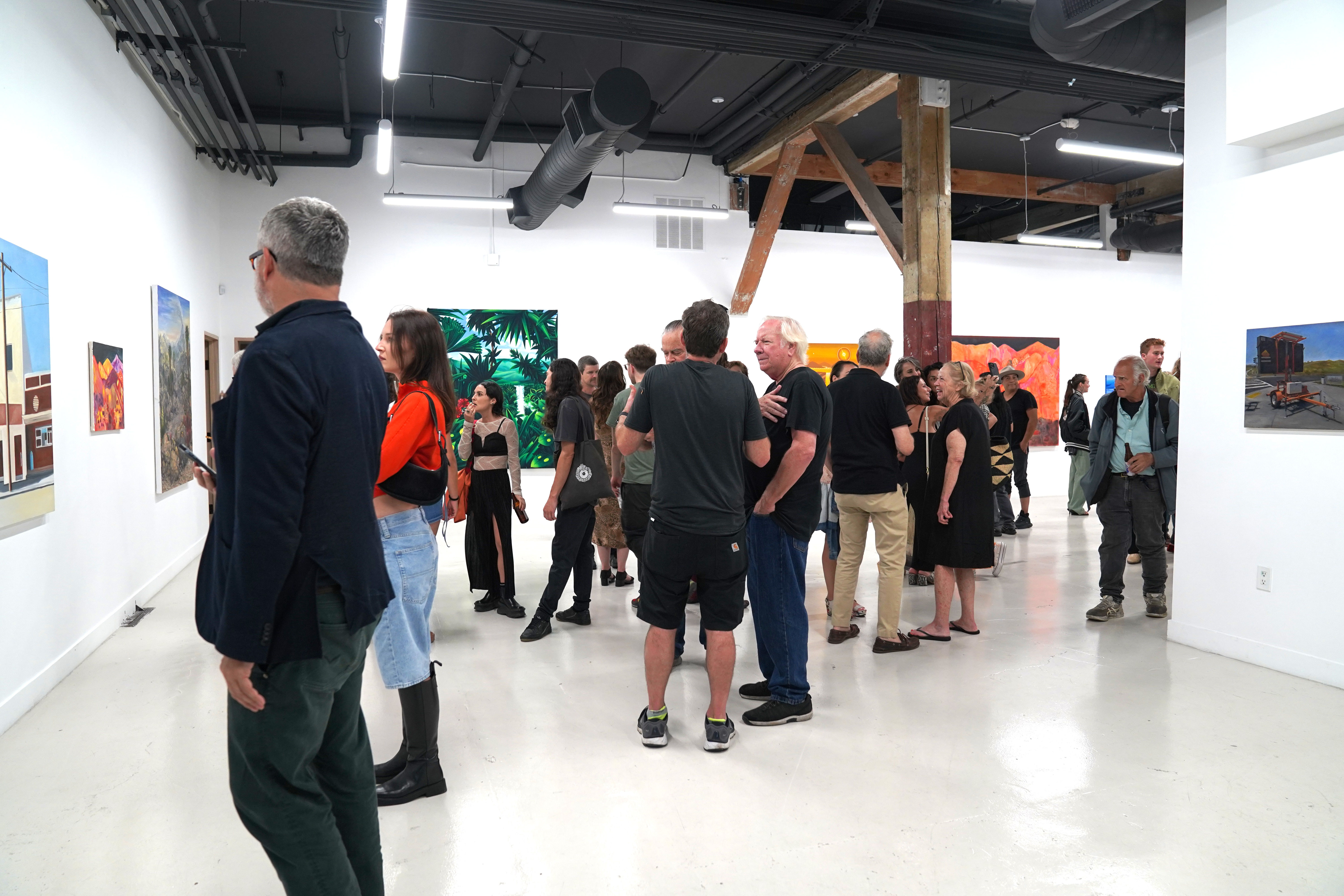 photo of an art gallery full of people