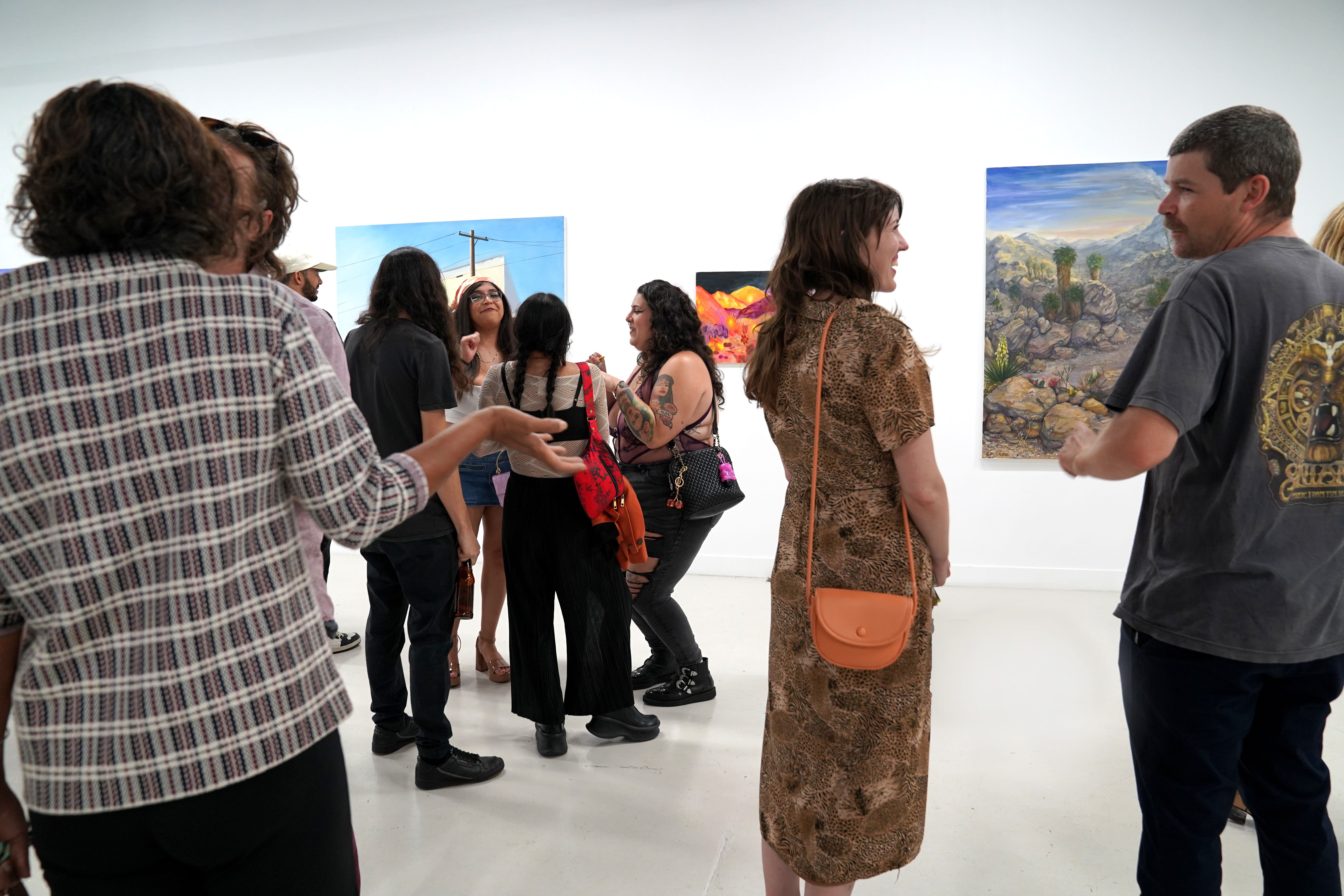 photo of an art gallery full of people