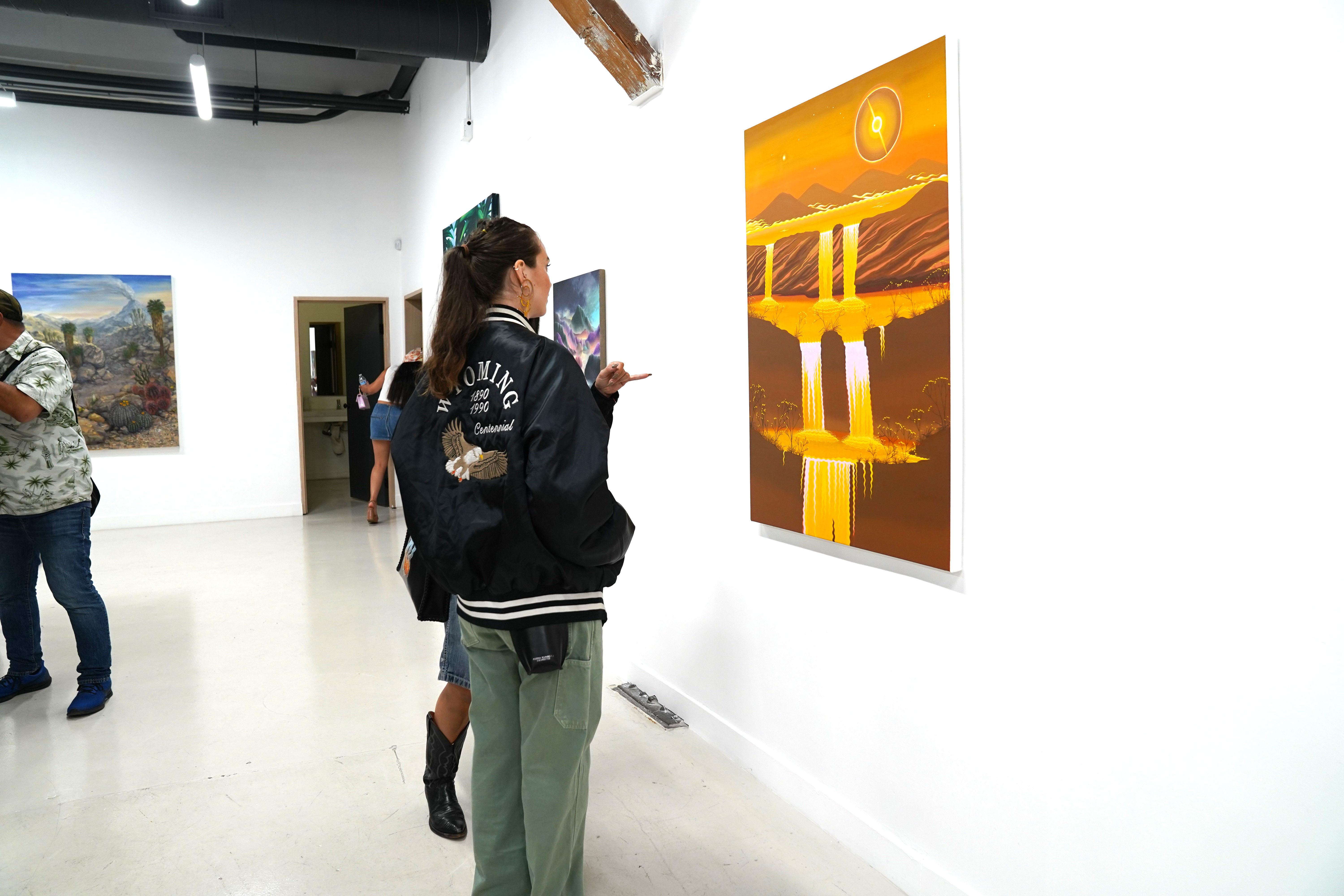 photo of an art gallery full of people