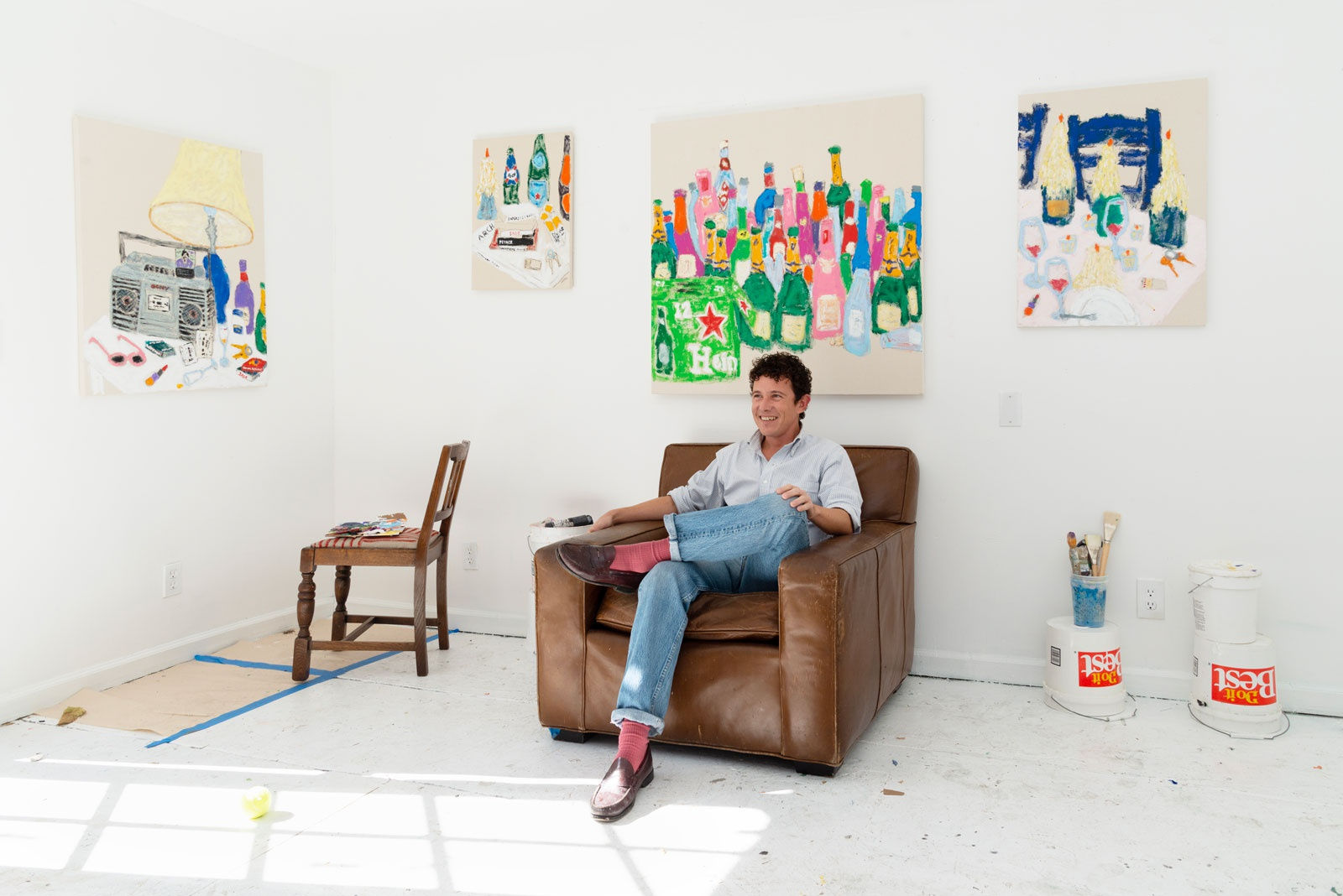 Michael McGregor sitting in an armchair in his studio