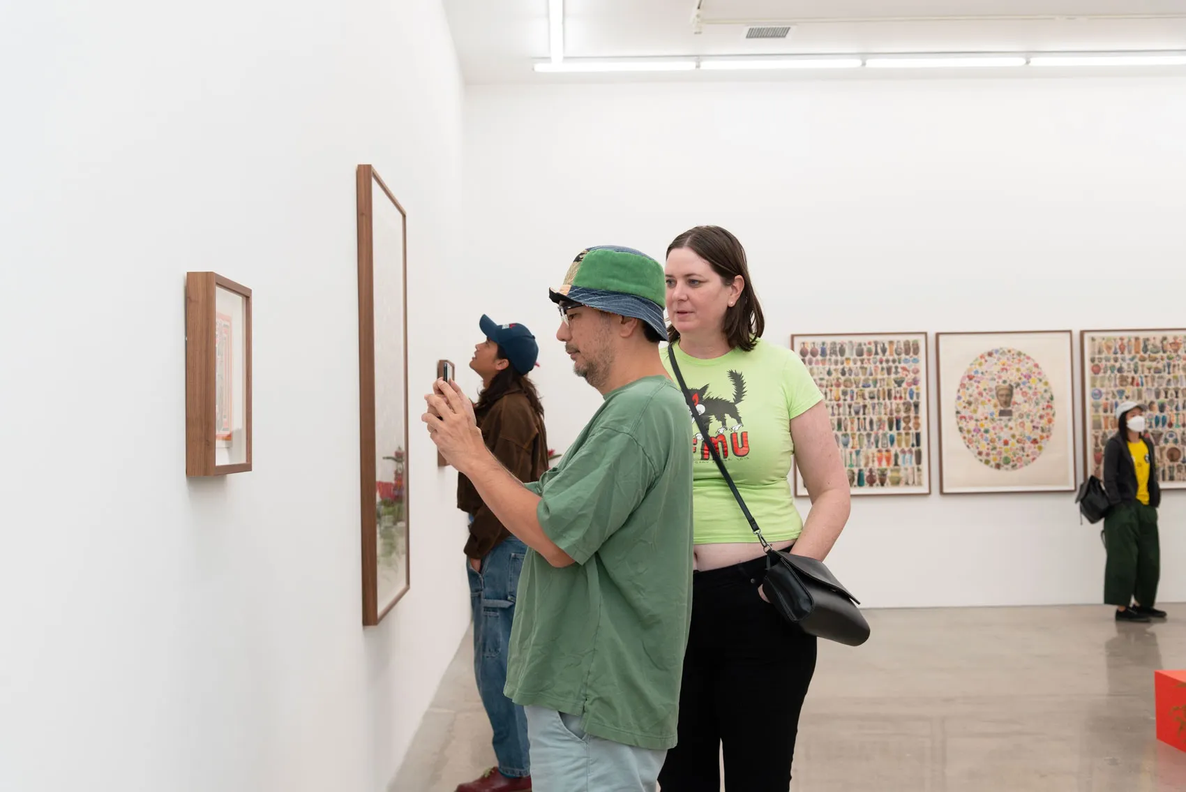 Attendees at the opening of Matthew Craven's solo show FOLK::LORe snap pics of the works. 