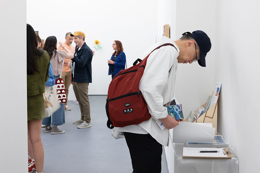 a person looking at the price sheet at the amuse-bouche opening reception