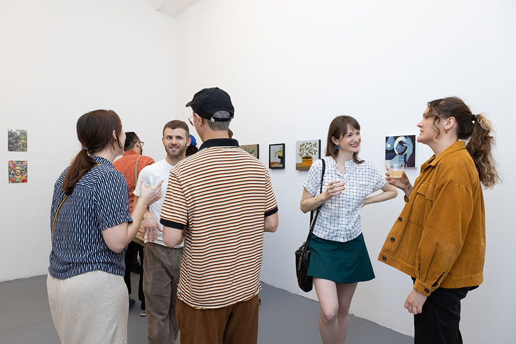 people talking at the amuse-bouche opening reception