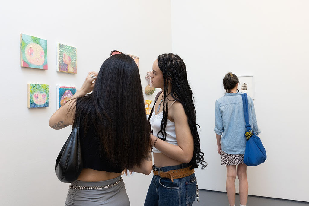 people looking at art at the amuse-bouche opening reception