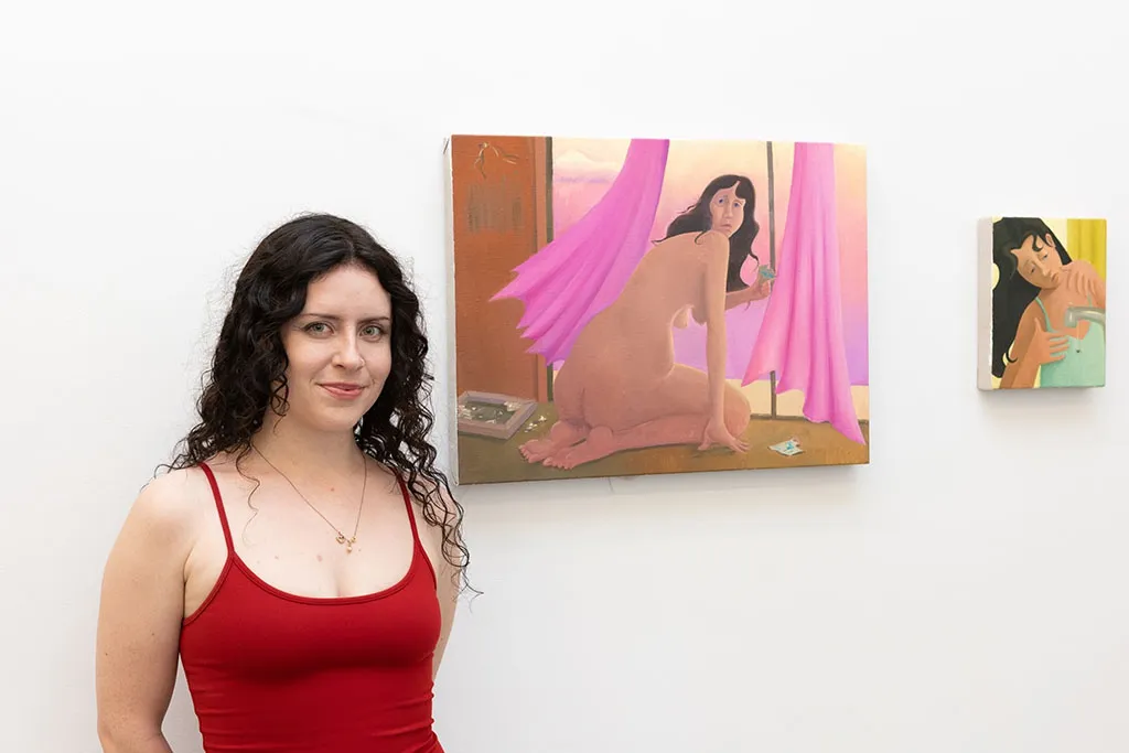 Artist Natalie Terenzini standing with ehr work at the opening for Left Unsaid at Hashimoto Contemporary