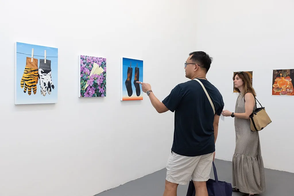 People standing and looking at art