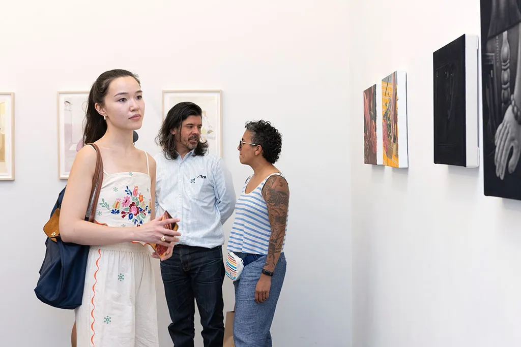 people standing and talking at the opening of Left Unsaid at Hashimoto contemporary