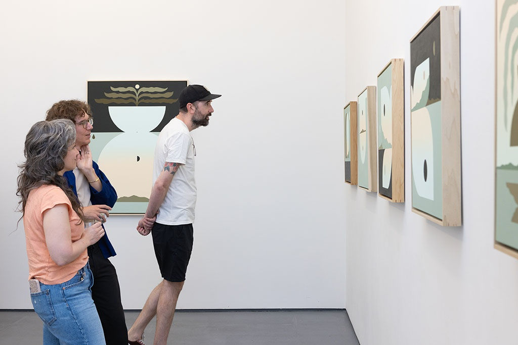 poeple looking at art at opening of madeleine Tonzi's The Moon Underwater