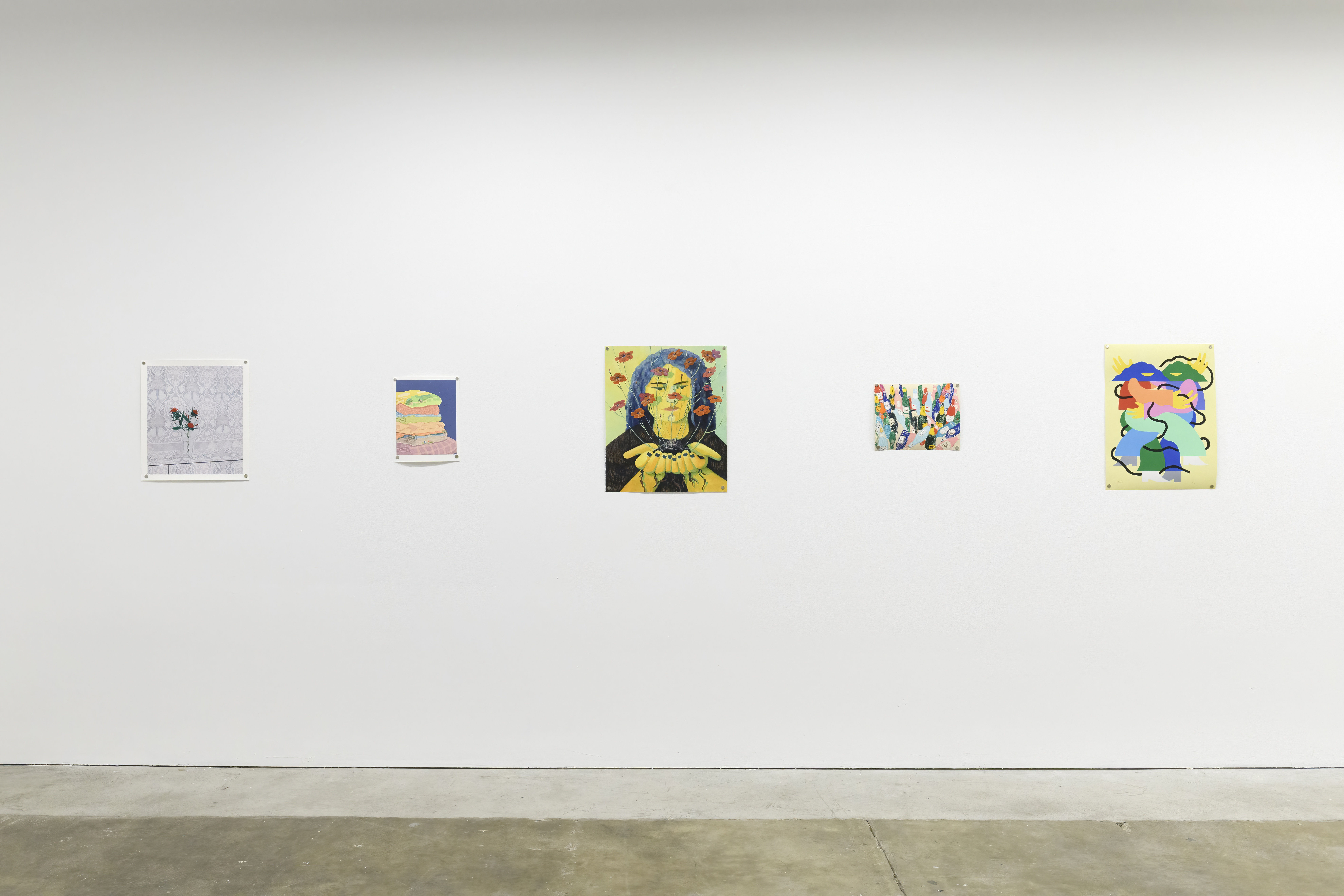 Prints of artworks on a white wall in an art gallery with fluorescent lighting.