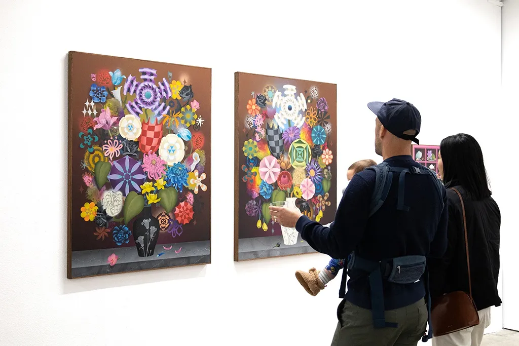 People looking at Casey Gray's bouquet paintings