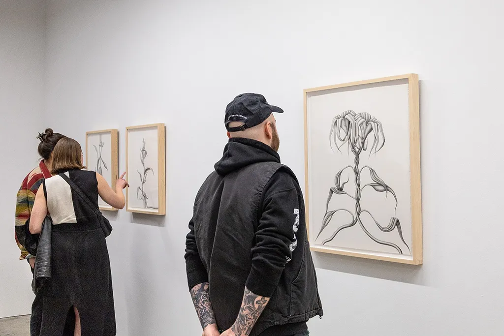 People look at Devra Fox's solo exhibition on the opening night. 