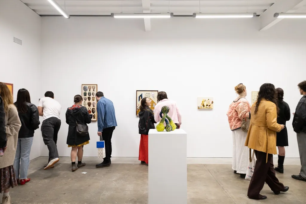 People mingle at the openign reception of Devra Fox's solo exhibition In Orbit. 