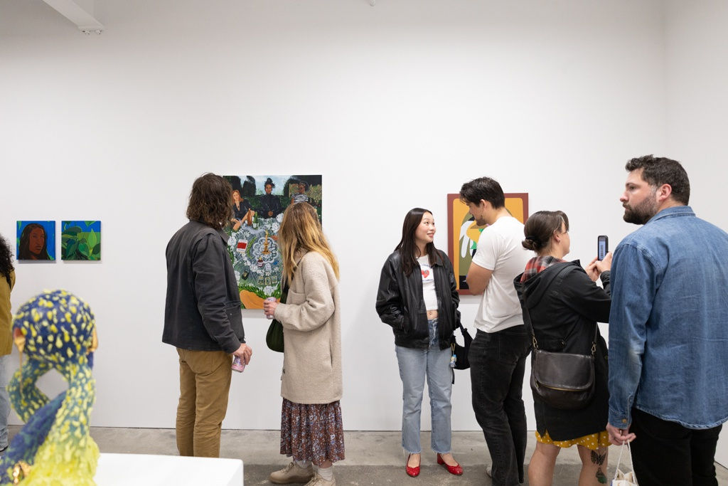 People mingle at the openign reception of Devra Fox's solo exhibition In Orbit. 