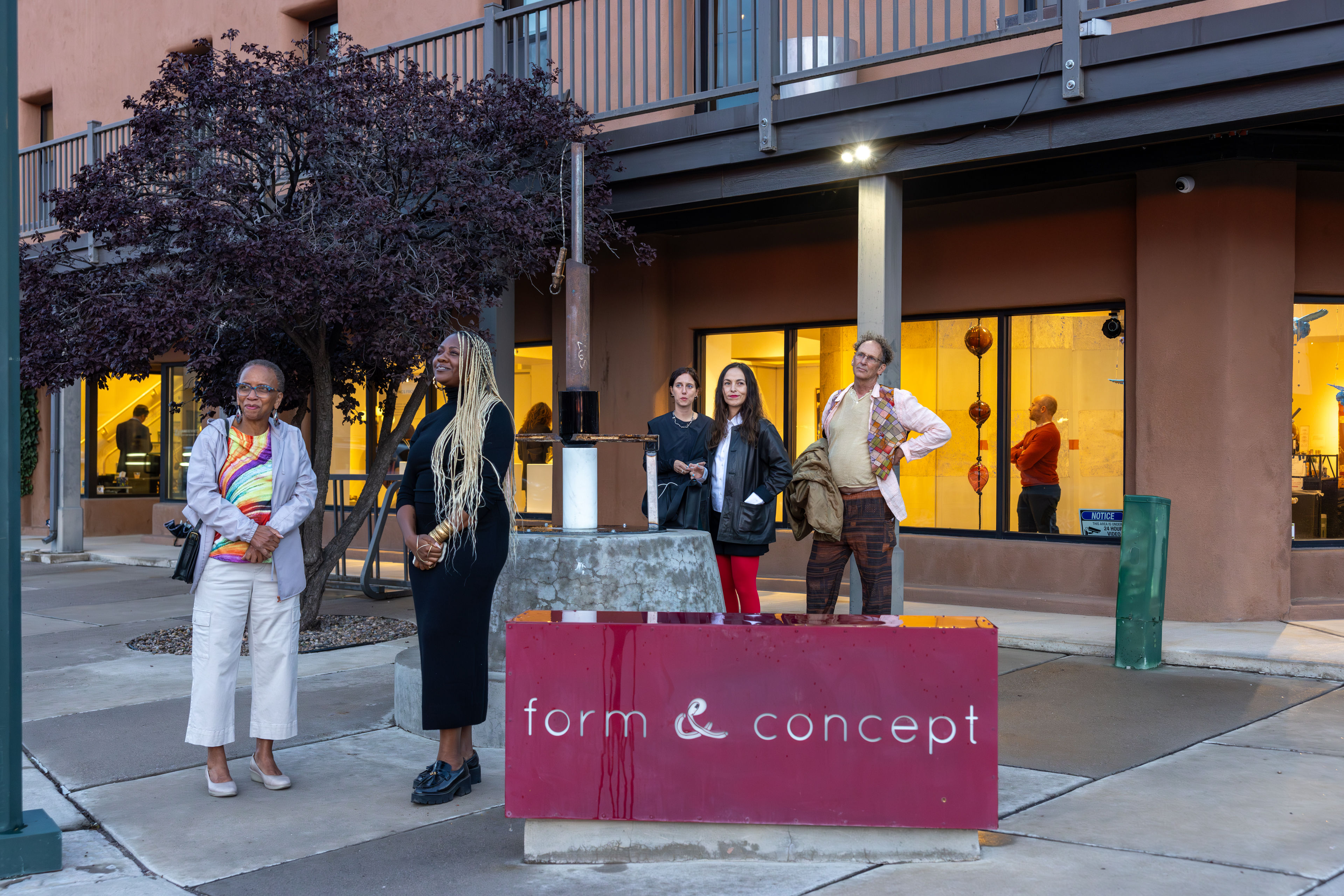 People gathered around outdoor sculpture