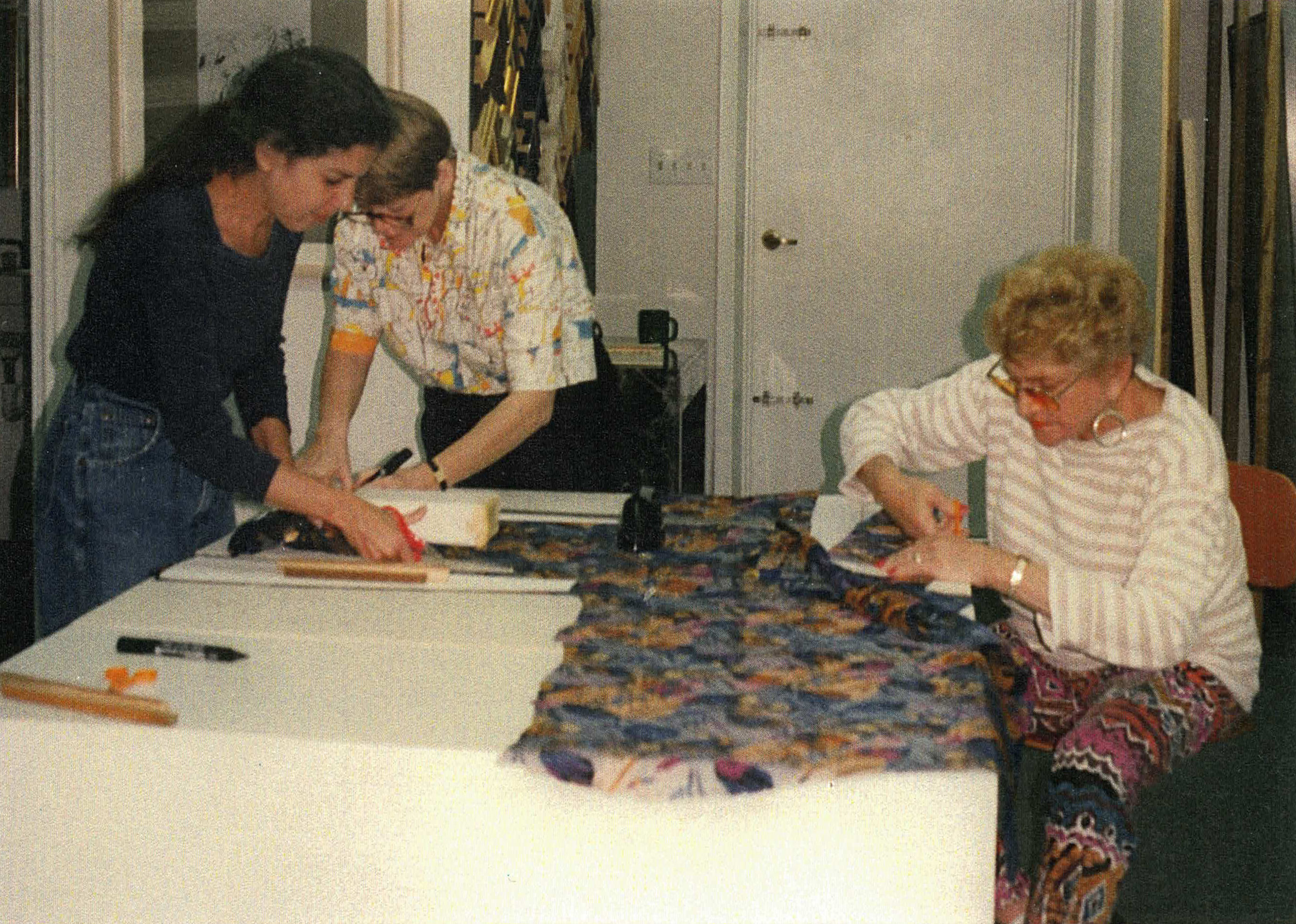 Miriam Schapiro cuts fabric for her prints