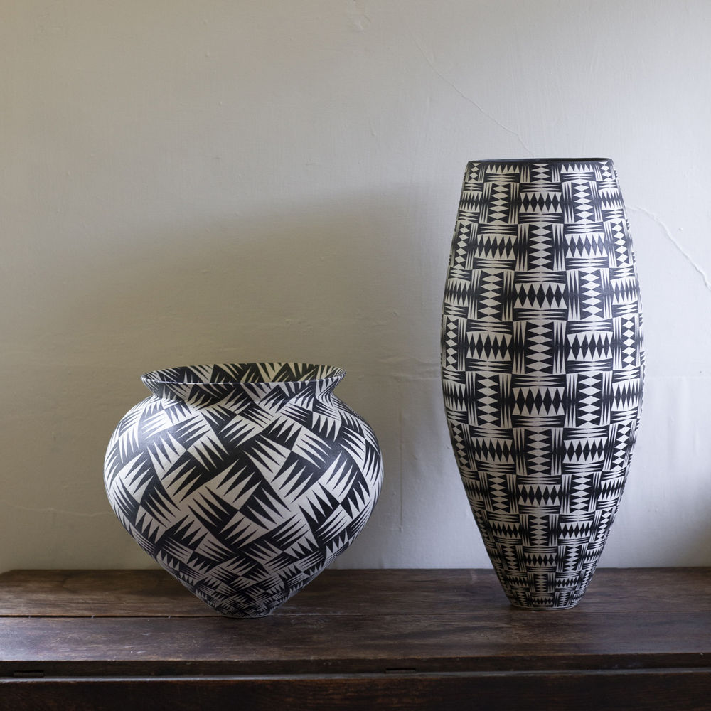 Ant & Di Edmonds - Tydd Pottery, two black and white ceramic vessels on a table