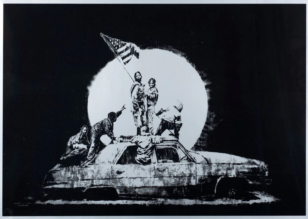 Banksy print, Flag. The artwork is a parody of Joe Rosenthal's iconic 1945 photograph, Raising the Flag on Iwo Jima. Instead of US marines, the image depicts urban youths in hoodies raising an American flag atop a burnt-out or derelict car.