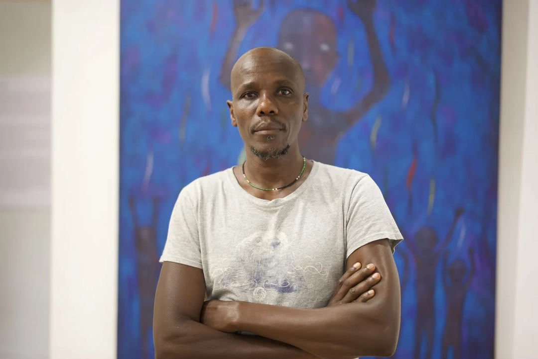 Richard Kimathi in front of one of his artworks | Photos & Videos | Almas Art Foundation