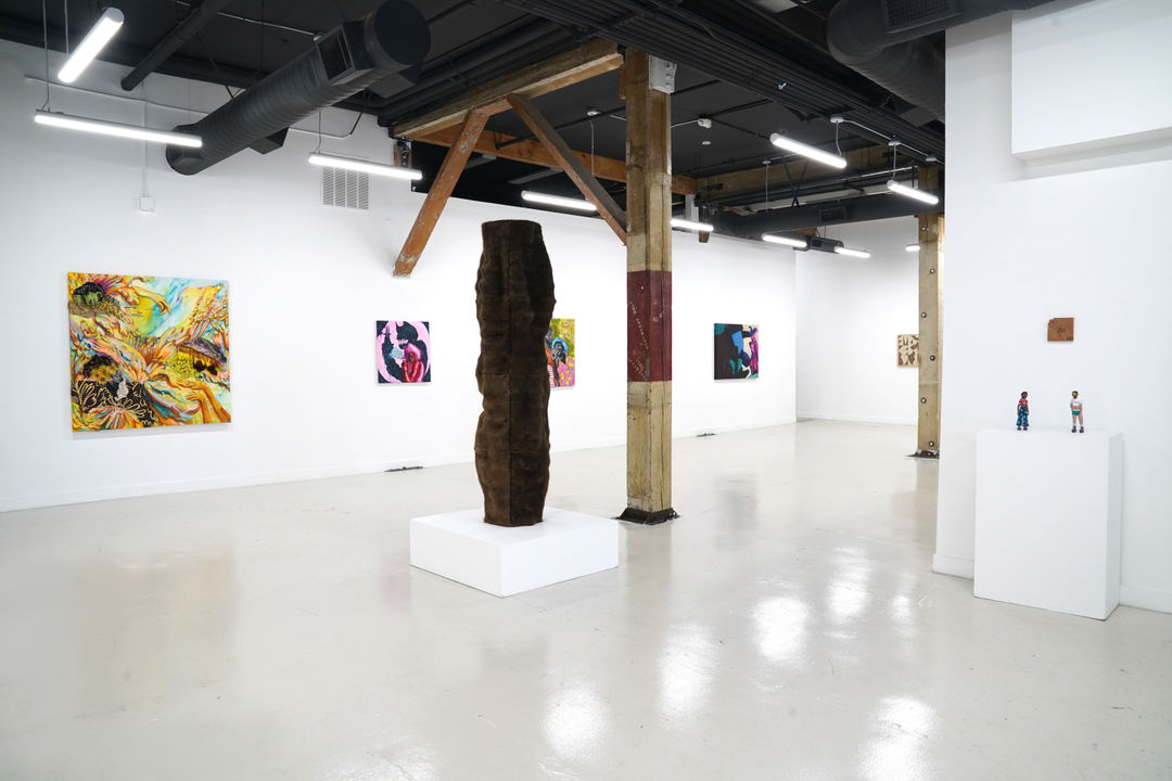 photograph of the gallery with paintings on the walls