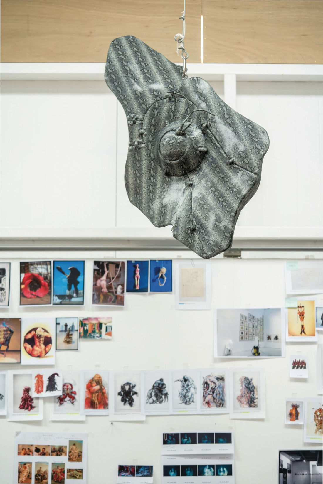 One of Lee’s sculptures hangs above a mood board (Photo: Tim Franco for Tatler Hong Kong)