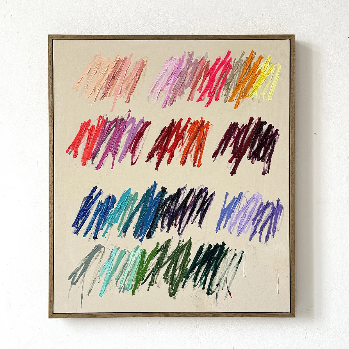 scribble painting by Christina Gschwantner hanging on a white wall. The painting is square with a darker beige backround and various colors of textured scribble markings arranged in a loose grid pattern